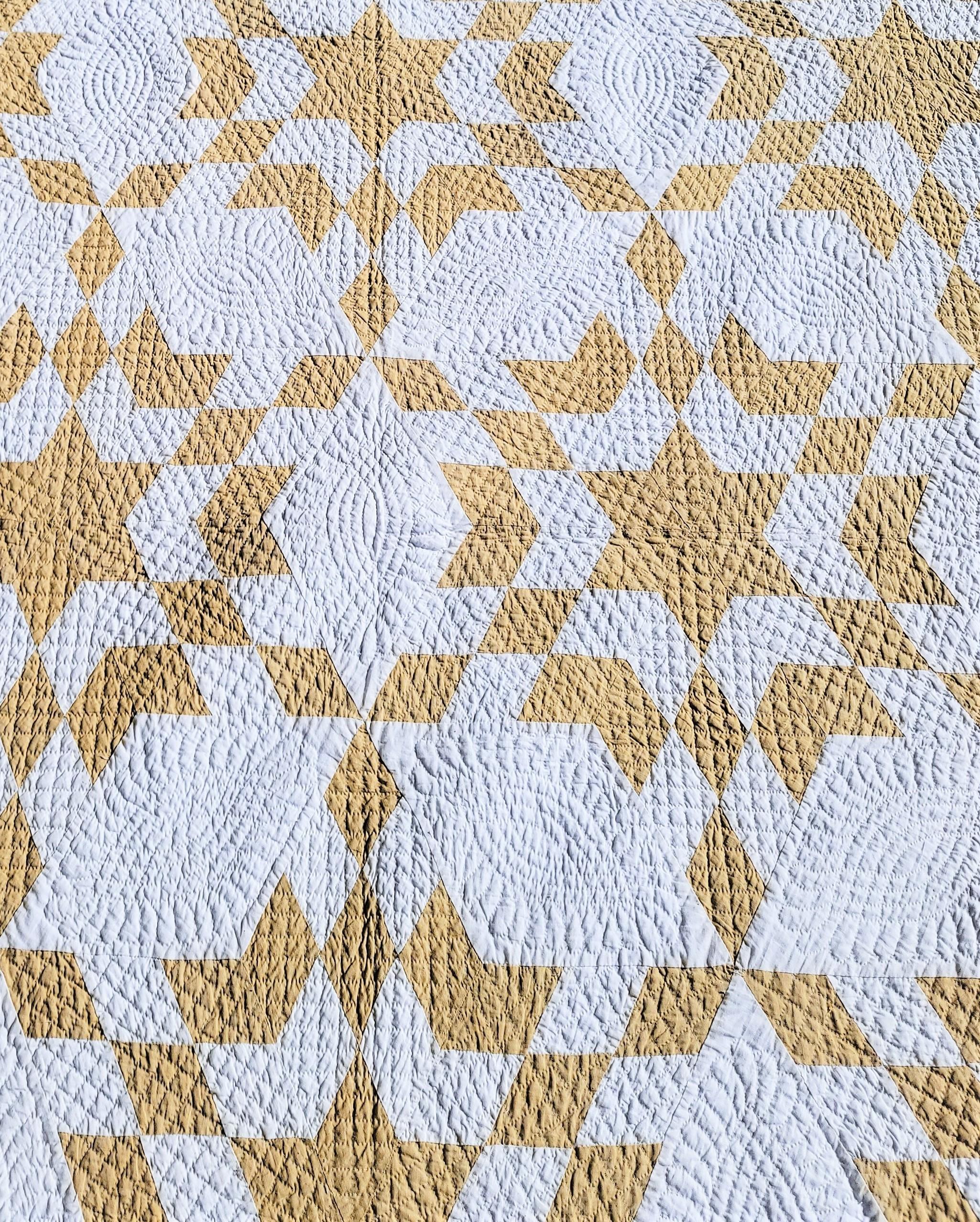 tan and white quilt