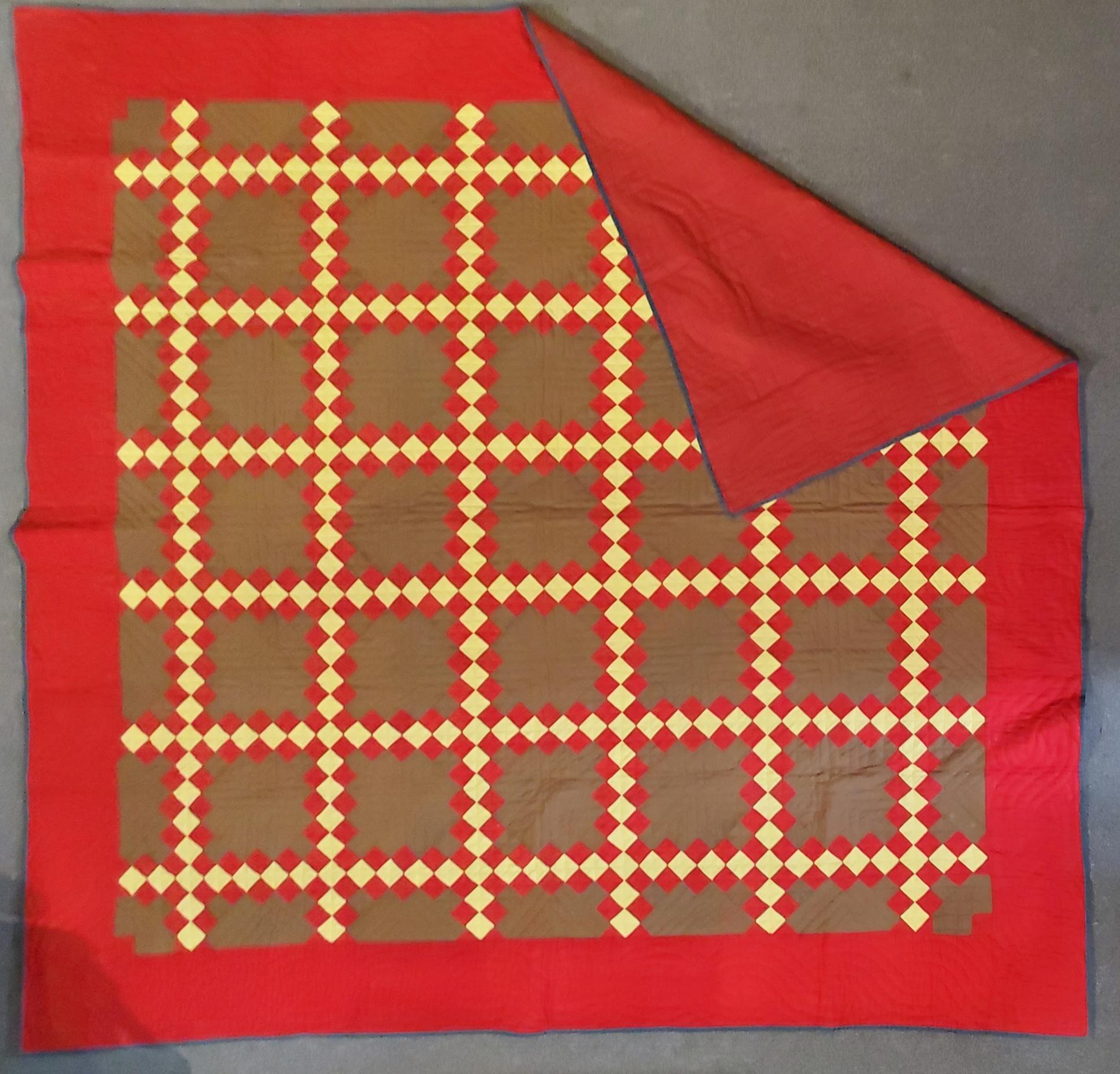 This finely quilted & pieced triple Irish chain quilt is in pristine condition. This fine turkey red border on a very early brown ground and a fine calico backing.