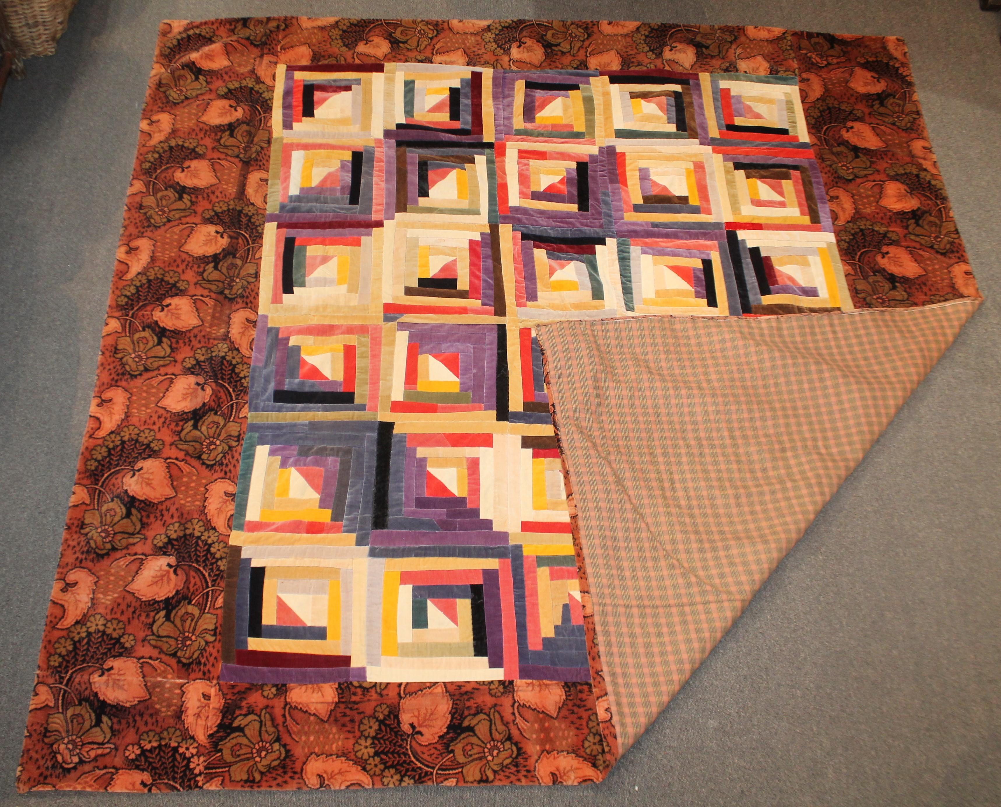 This fine and lux velvet antique quilt in a log cabin pattern with a printed velvet border is in fine condition. The backing is in a cotton plaid fabric. The condition is very good.