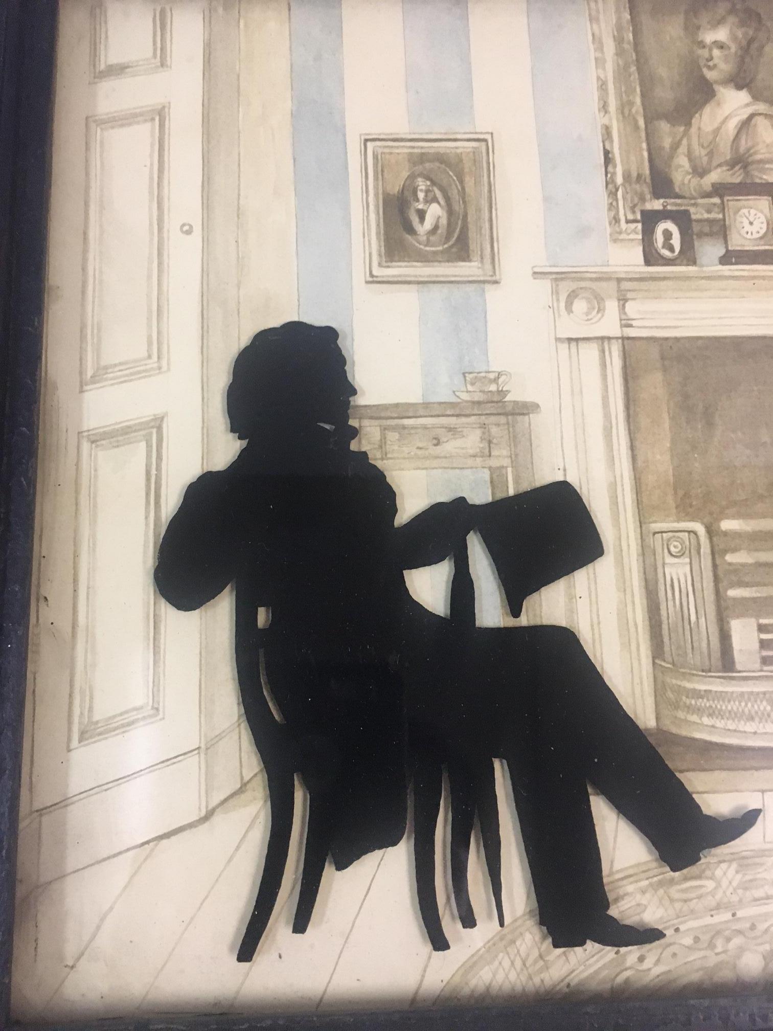 This unique and very well executed portrait of a mid 19th century couple done in silhouettes is adhered to glass as in Verre Eglomise with a very charming drawing of a parlor in the background.
Details to note: the handsome gentleman sits relaxed in