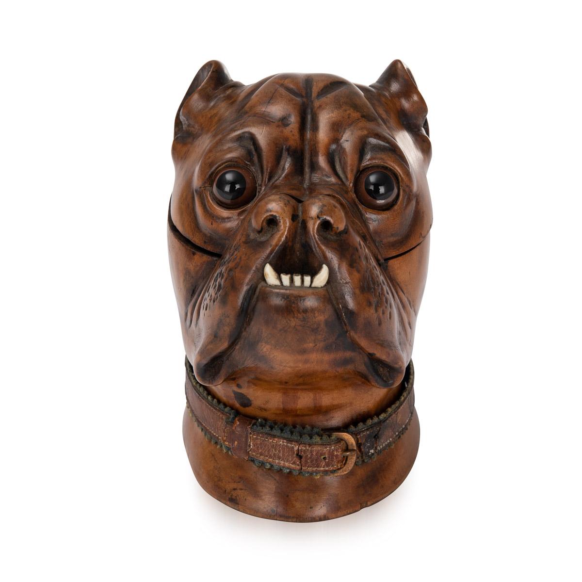 Antique 19th century Victorian lignum vitae inkwell modelled as the head of a bulldog with realistic glass inset eyes, original leather collar with a copper buckle and scowling teeth. The head is hinged and opens to reveal an empty ink pot insert