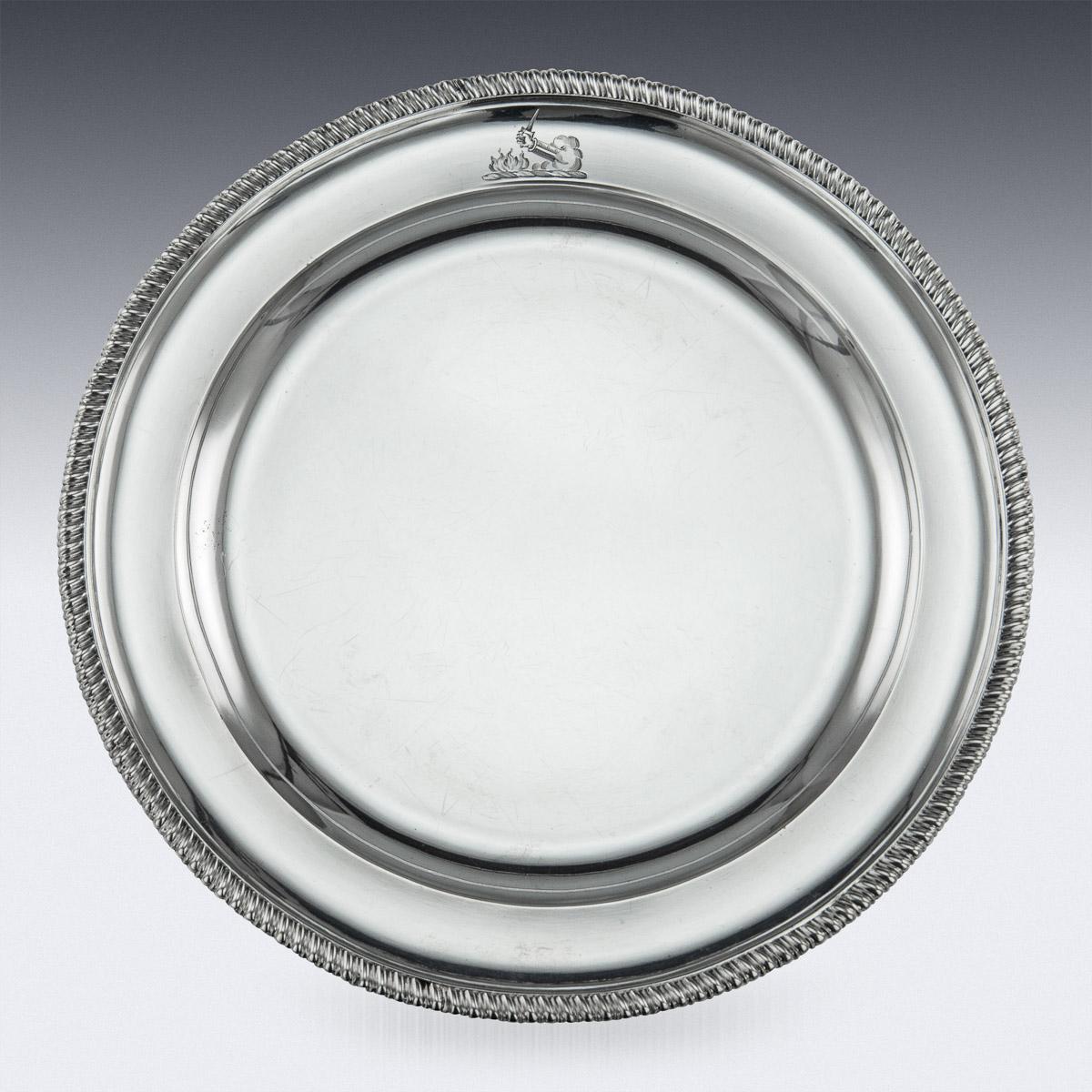 Antique mid-19th century Victorian important solid silver set of twelve dinner plates, each of shaped-circular form with gadrooned borders. Each border is engraved with a family crest of Sir Glynne Earle Welby-Gregory 3rd Baronet. (1806-1875), who