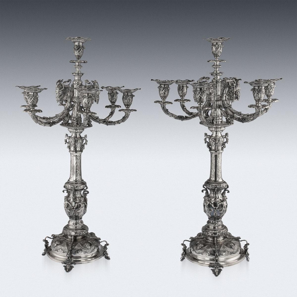 Antique 19th century Victorian exceptional & very unusual set of four solid silver candelabras. Each large seven-light and smaller four-light candelabra set with repousse neoclassical bobéches issuing from ram's head supports, decorated throughout