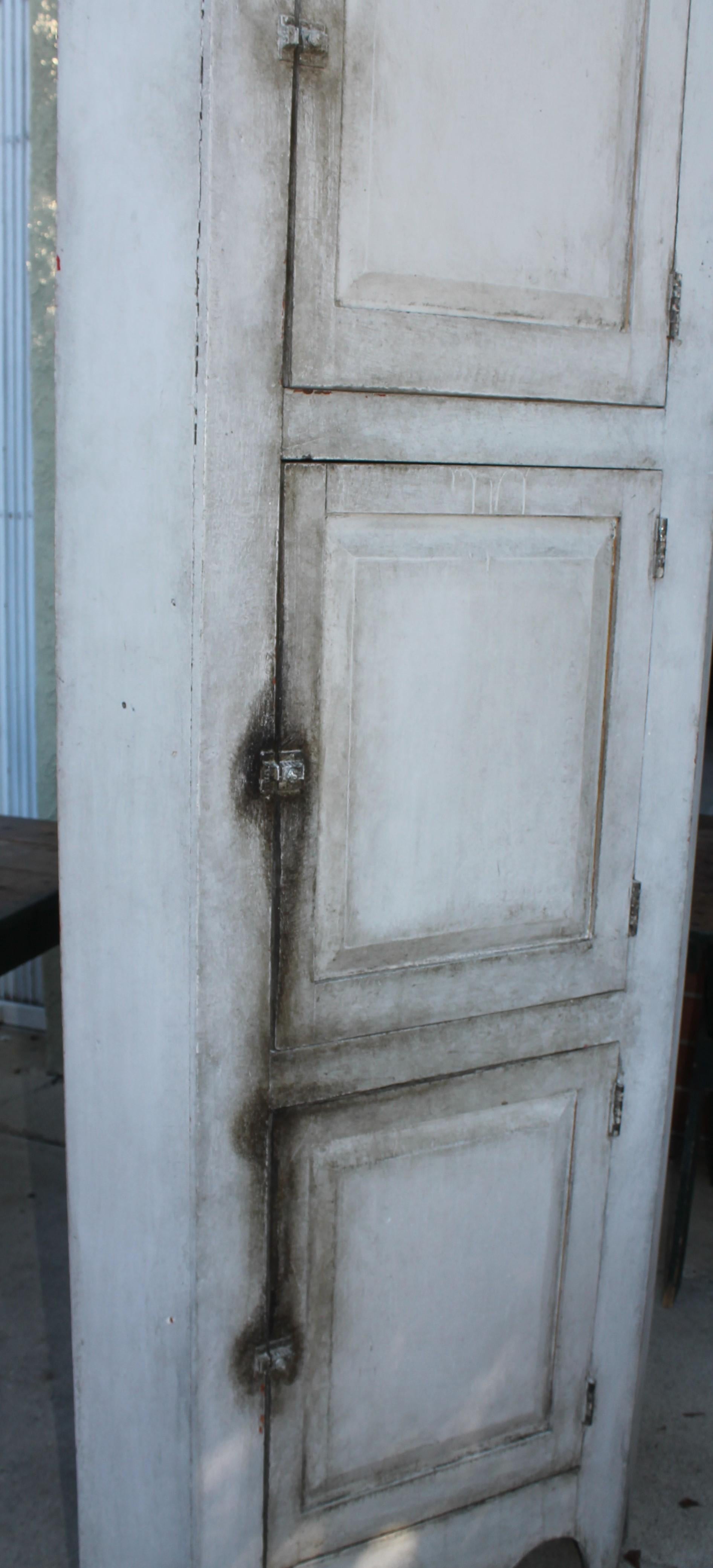 This amazing 19thc three door corner cupboard is in great condition and good and sturdy condition.This cupboard is over painted and has a dusty rose painted interior. The backing is in old wainscoting.
The hardware is all original and locks up