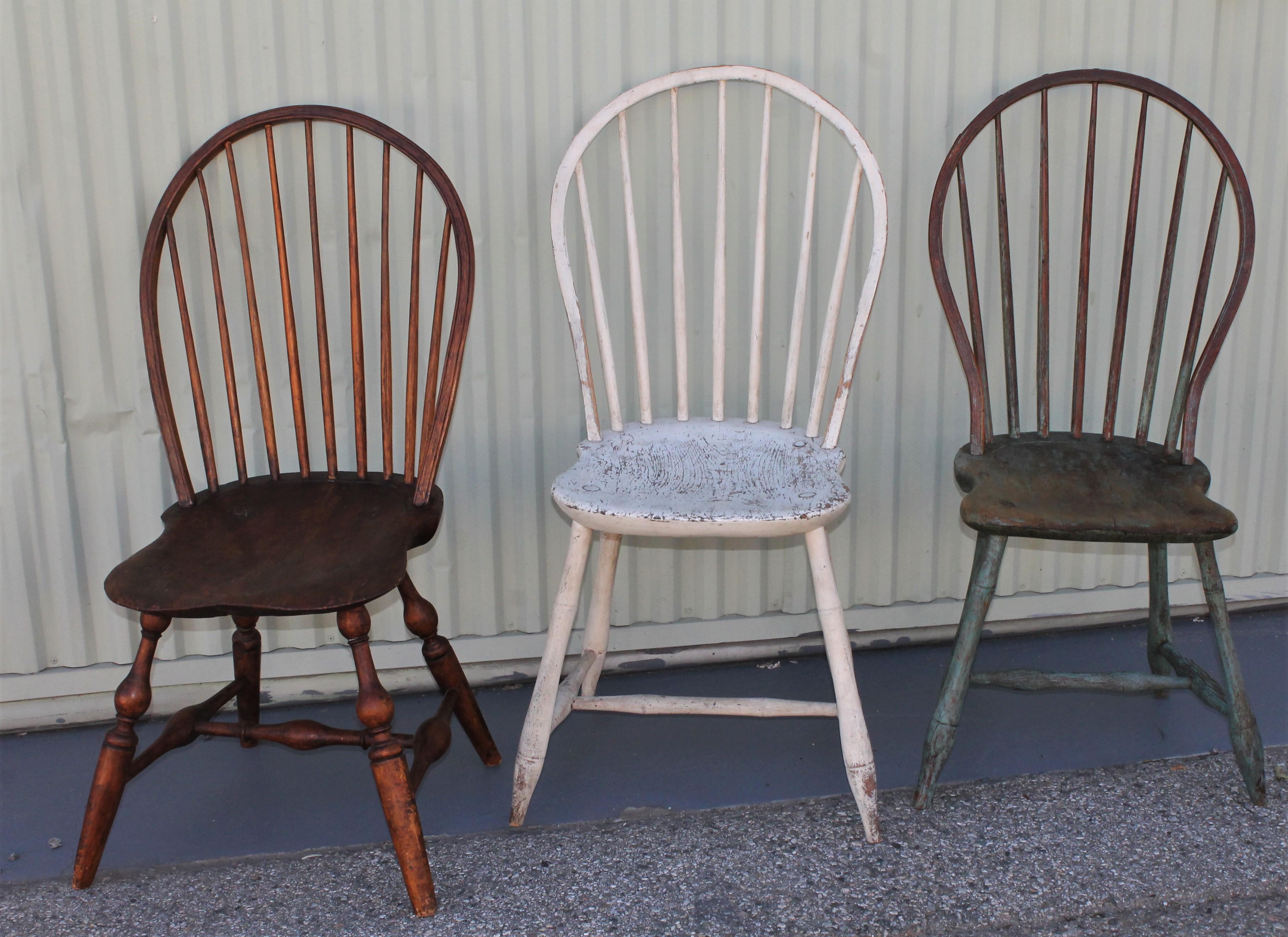 These amazing all original painted Windsor chairs are in good condition and have a wonderful worn and aged patina. The three chairs are in very good sturdy condition. The blue painted chair has a amazing patina and well worn seat. The white painted