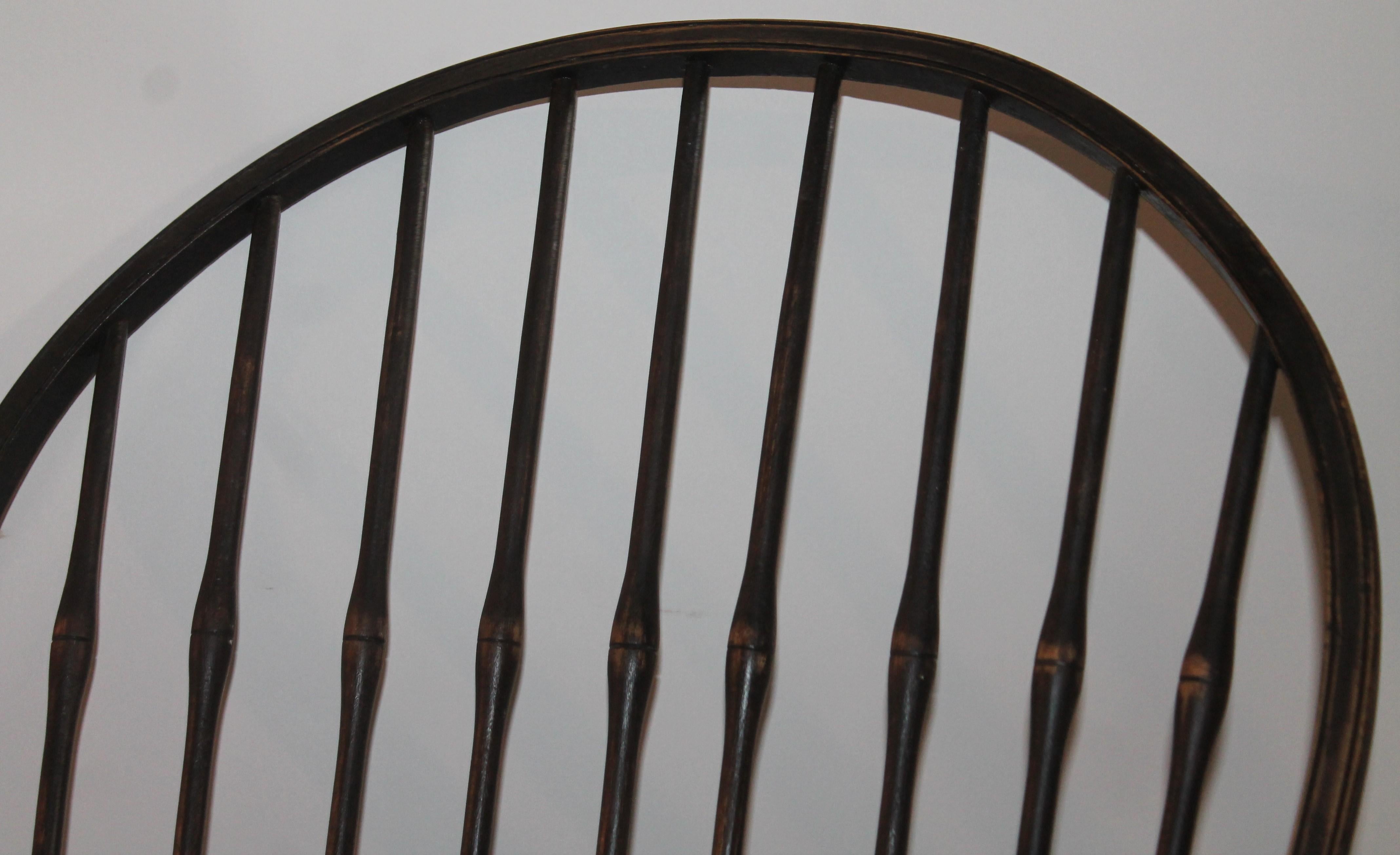 This 19th century Windsor chair is in fine condition and has a black original stain finish. There is a label on the bottom of the seat. It is from Suracuse, New York and made by Edmonds Furniture Company and retains the original makers label. The