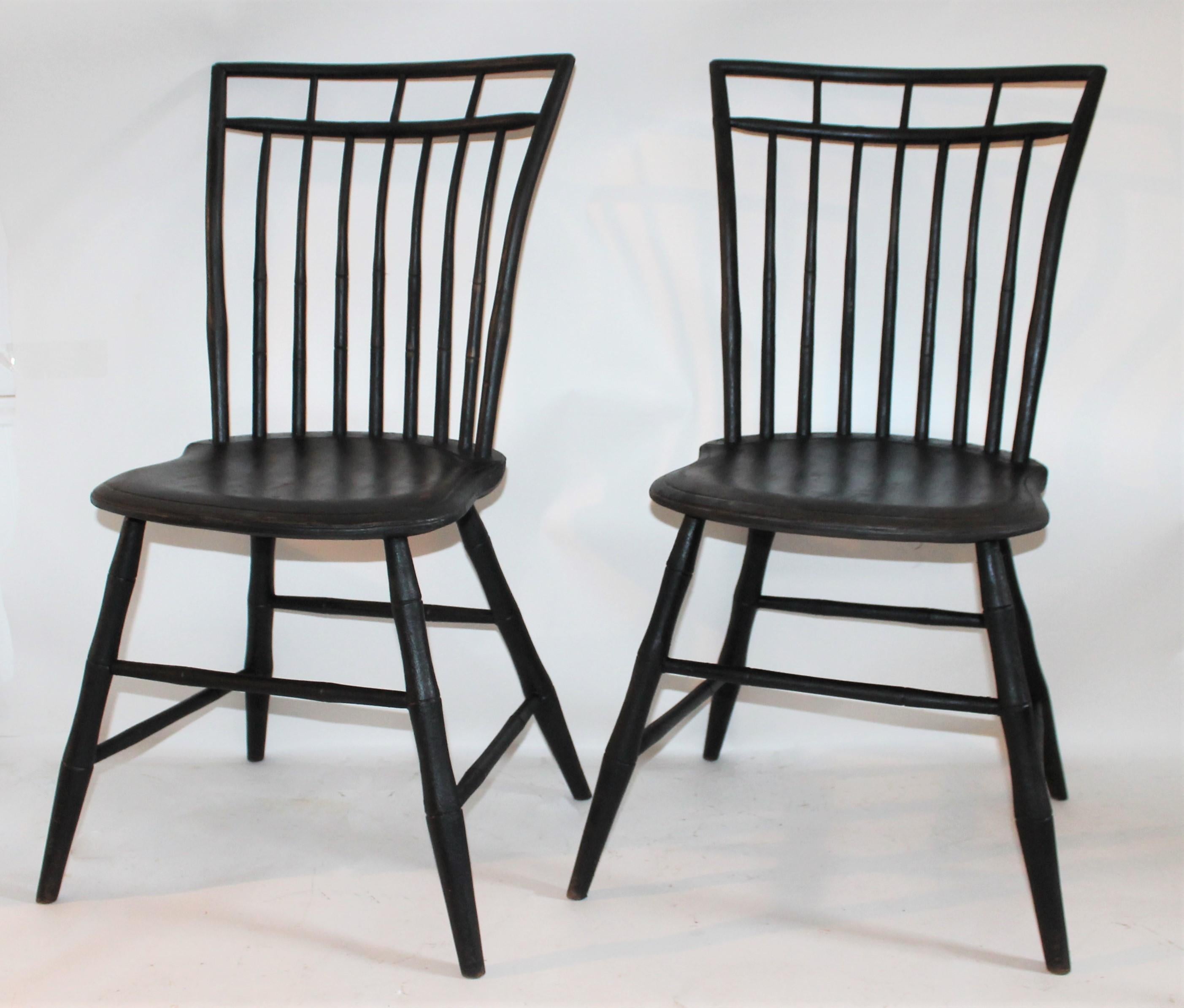 19th century original painted black over dark chocolate birdcage Windsor chairs. The condition is very good with wear on the seats consistent with age and use.