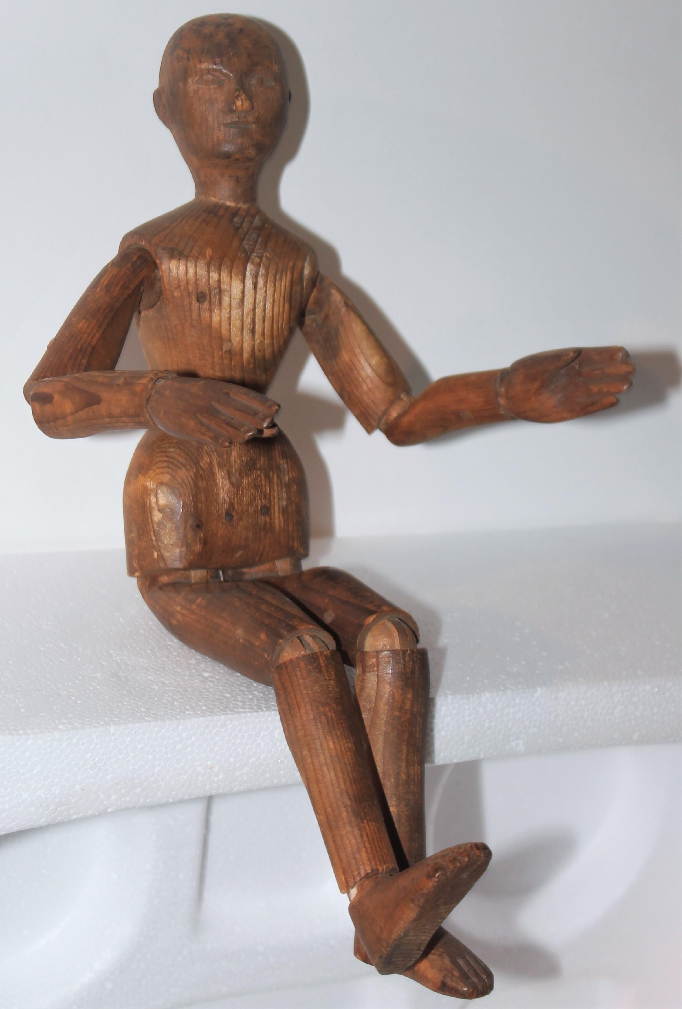 This fantastic hand carved wood articulated mannequin is very early 19thc and is all wood pegged. The condition is very good with a fine patina. This hand carved sculpture has a fine patina and slight wear to the nose and hands.