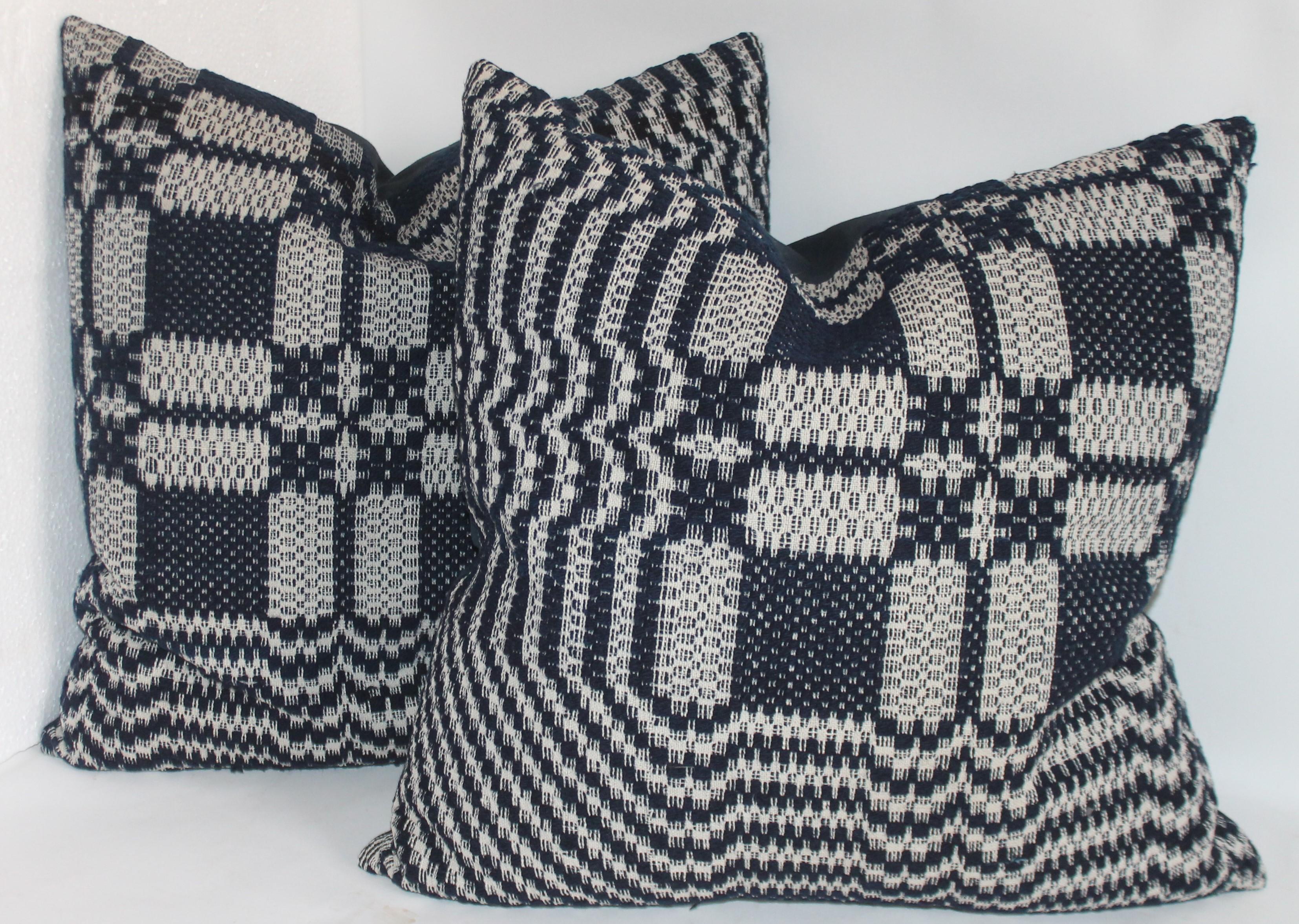 These four jacquard coverlet pillows are in fantastic condition and have blue cotton linen backings. The inserts are down and feather fill.