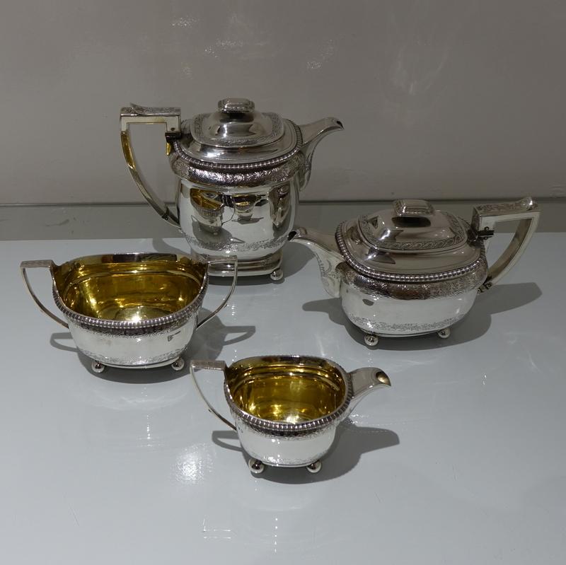 A rare and very good quality four piece Georgian silver tea and coffee set decorated with gadroon borders and elegant bands of intricate floral bright cut engraving.

 

Weight: 65 troy ounces/2025 grams

Height

Coffee pot: 8