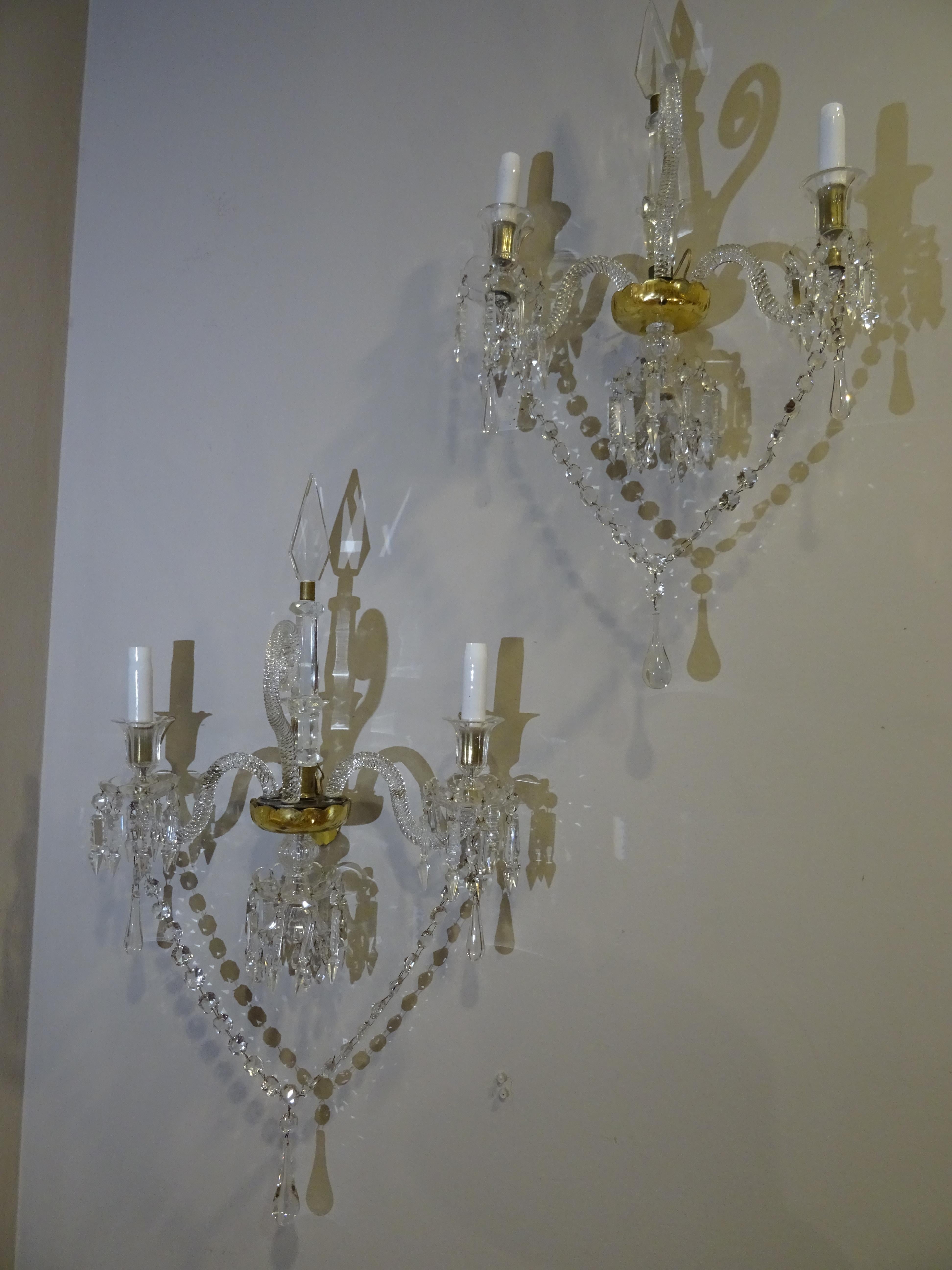 An amazing couple of glass and golden glass Baccarat white glass sconces. In a Luis XV style and Napoleon III period. With 2 arms and a central shaft all in carved crystal at diamond tip. Center of the pieces in gold azogado crystal.
Exquisite
