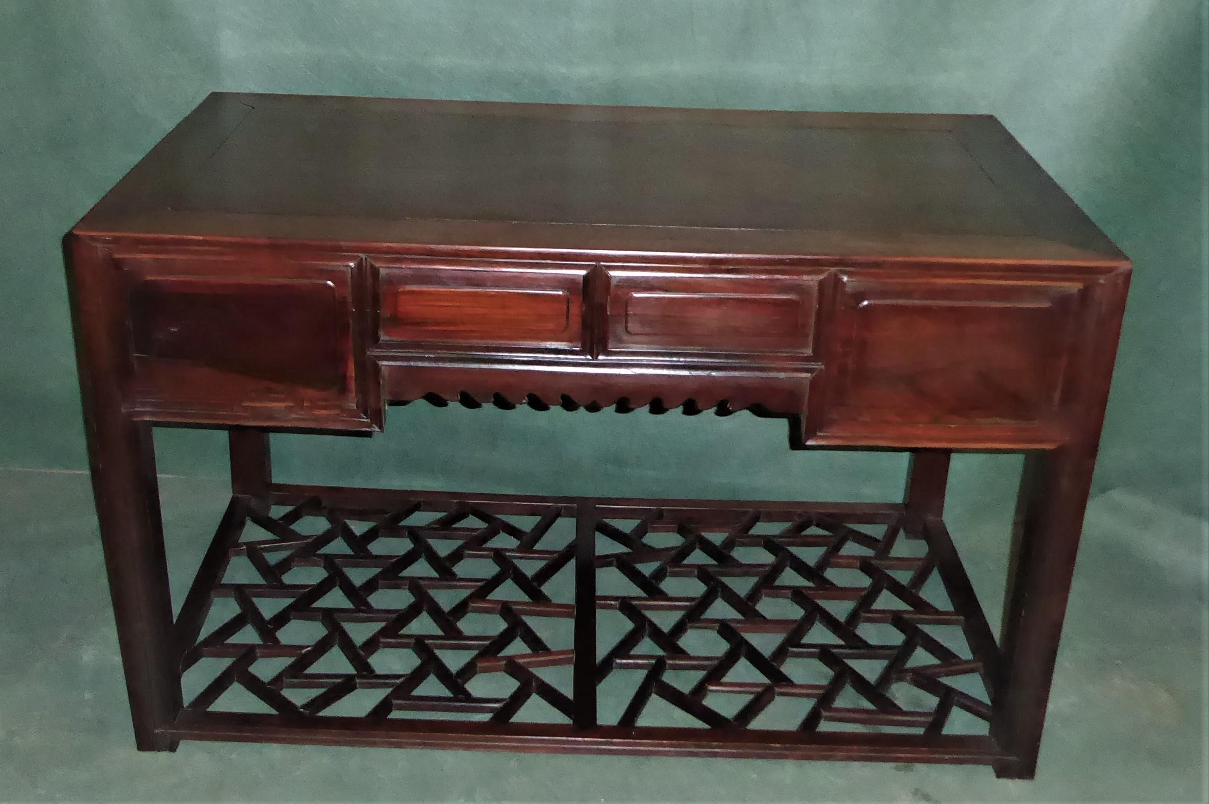 19th century Chinese centre table or desk with four drawers, panelled back and sides and fretwork base, a most attractive and interesting piece admired by all who view this piece being both useful and a delightful furnishing piece.
Highly