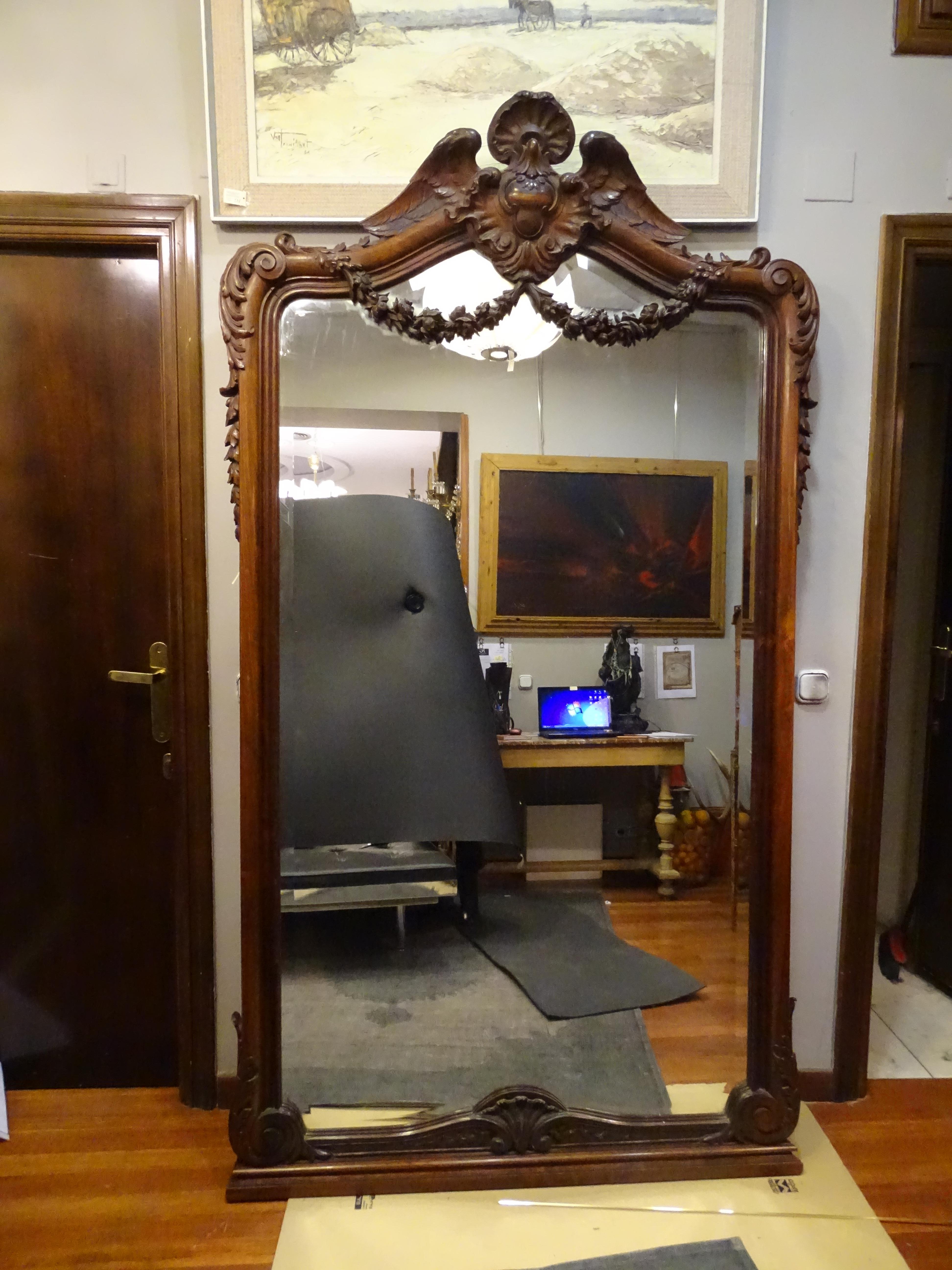 Amazing huge Napoleon III French wall mirror in carved wood, solid walnut.
In very good condition with age and use.
Up the mirror there is a large dove with big open wings. Scrolls and rockery frame the profile of the mirror. Some garlands of