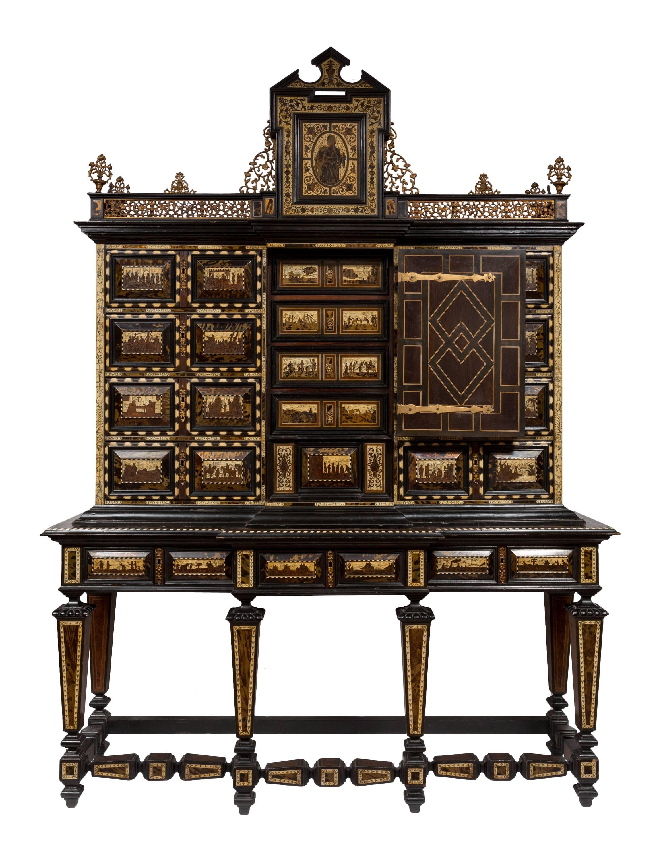 Large-scale 19th century Spanish bargueño / vargueño (secretary/desk) decorated with scenes of Columbus discovering the New World.
Thirty-one detailed vingettes created in bone and tortoiseshell inlay illustrate drawer fronts showing various