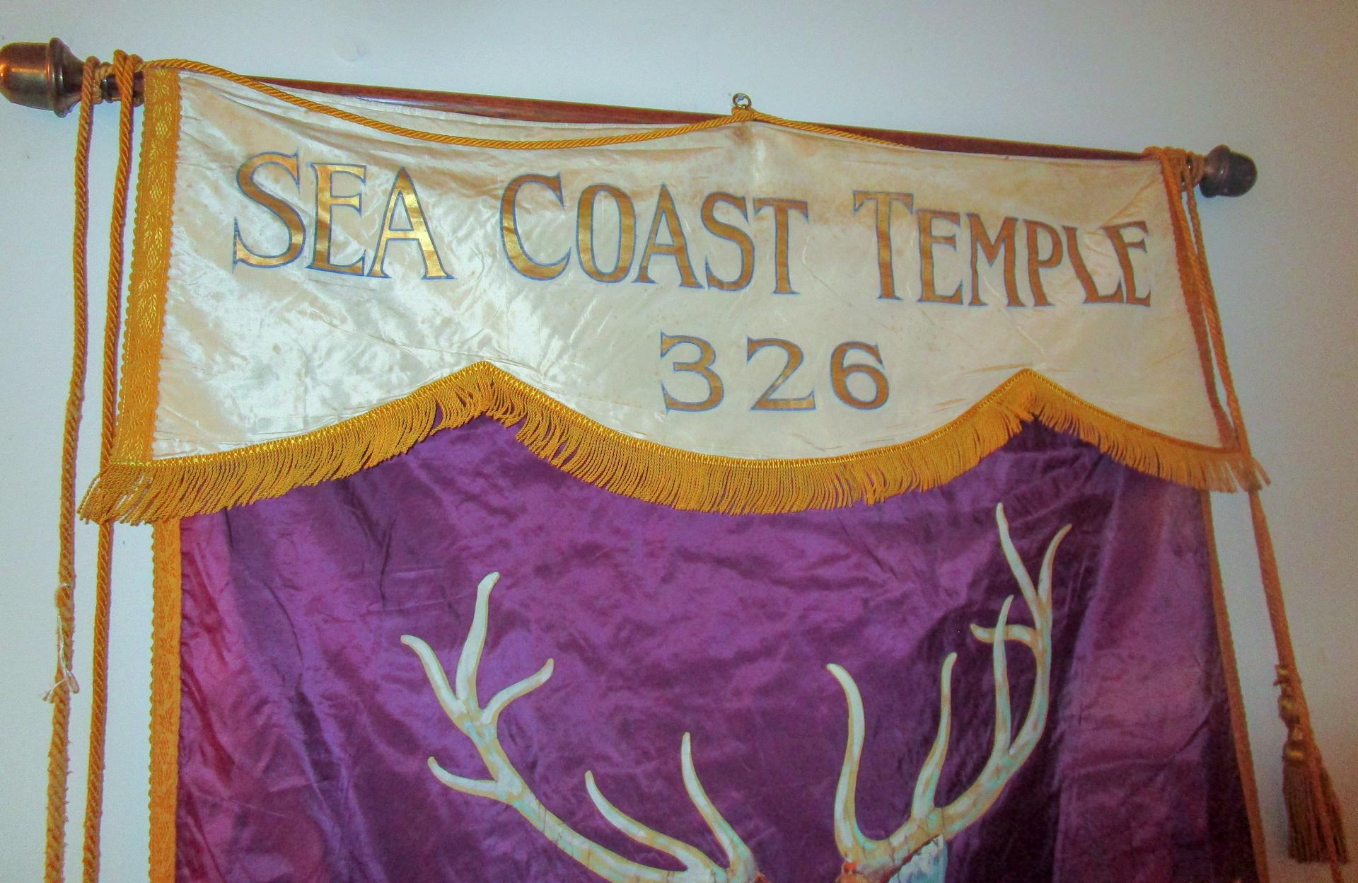 Large very detailed banner from the Elks Lodge hangs on a long brass rod with fringe and tassels.The I.B.P.O. stands for the Improved Benevolent and Protective Order of Elks of the World. This particular one is from the Atlantic Seacoast Chapter,