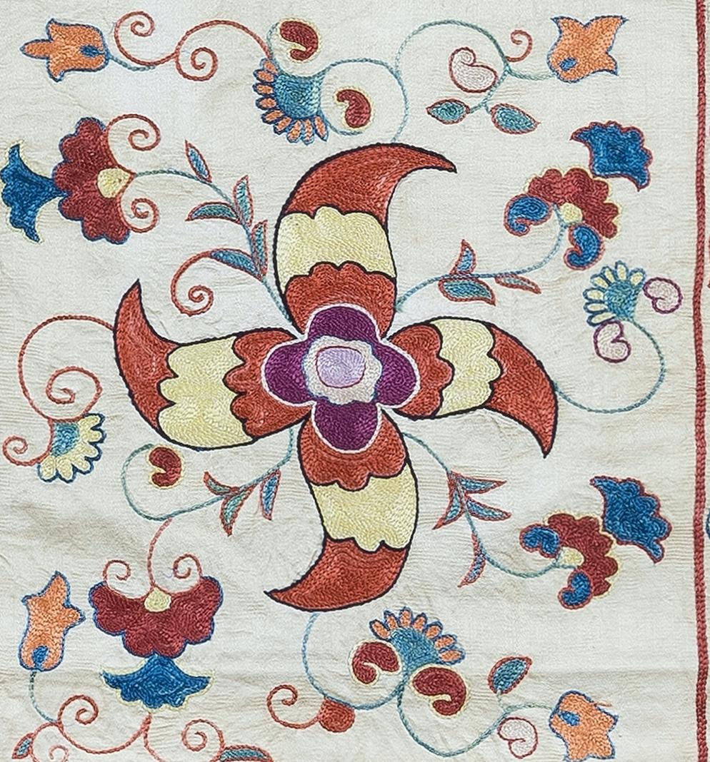 Decorative Suzani cushion cover featuring hand embroidered silk on silk background, flowers and vine motifs, linen backing with zipper, no insert.

Delicate and specialised washing advised. Measures: 19