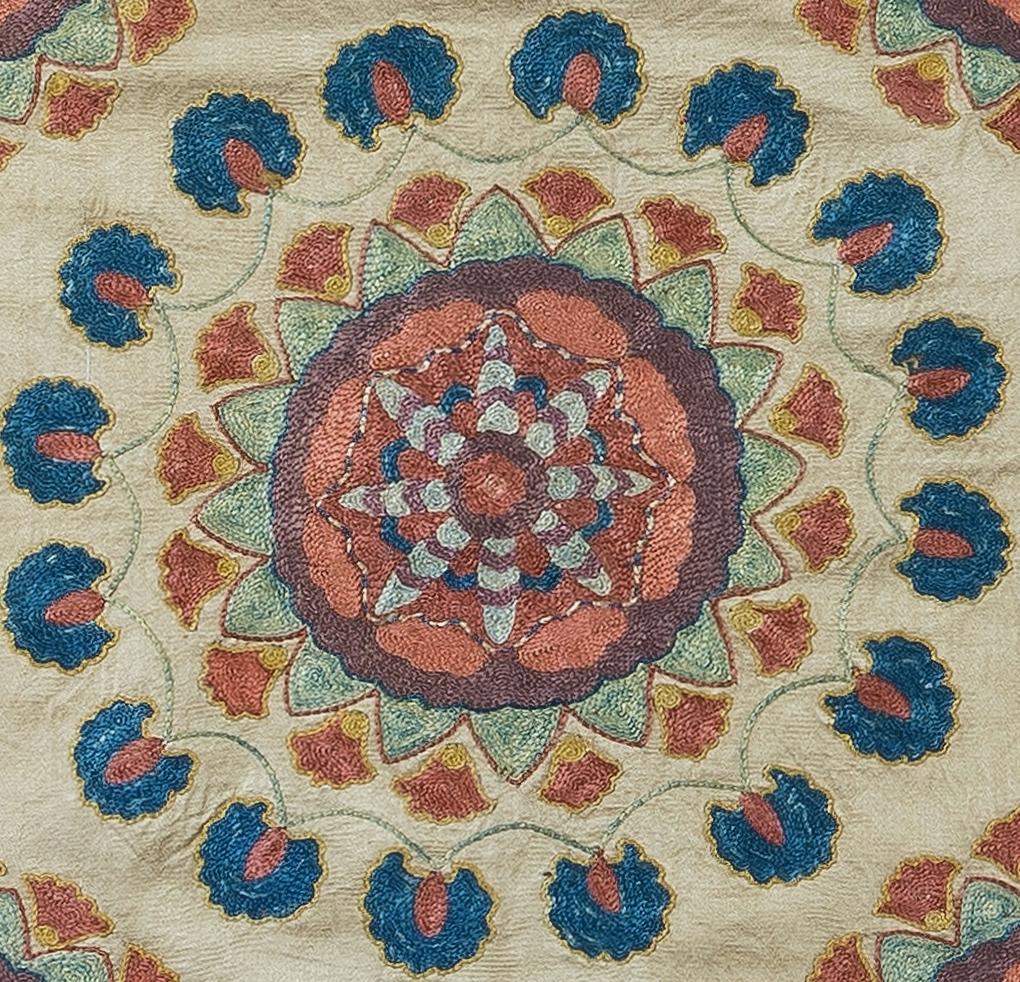 Decorative Suzani cushion cover featuring hand embroidered silk on silk background, flowers and vine motifs, linen backing with zipper, no insert. Measures : 19
