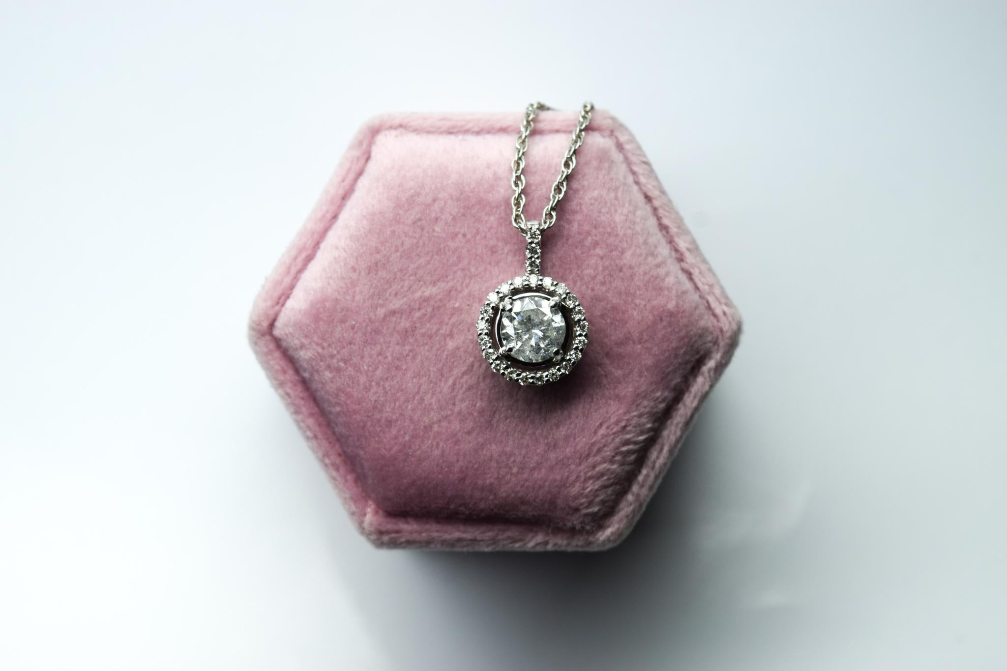 1ct center diamond I1 clarity and G color made with halo of diamonds SI clarity and G color in 14Kt white gold, the chain is 18