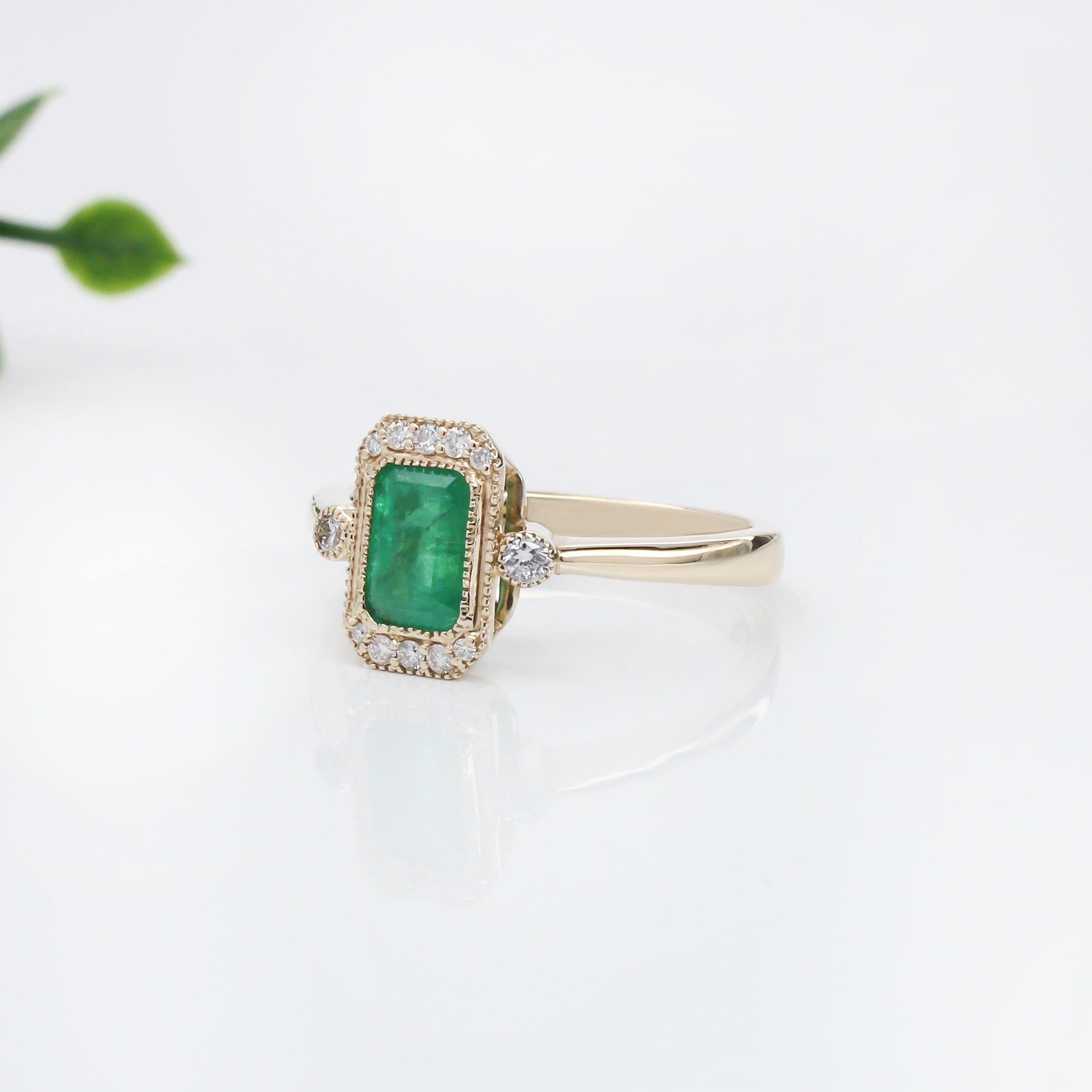 This elegant ring features a 1.07 carat emerald cut Emerald gemstone, beautifully encircled by a halo of shimmering natural earth mined diamonds. The emerald is set in a polished band, accentuating its rich green color. The design is refined,