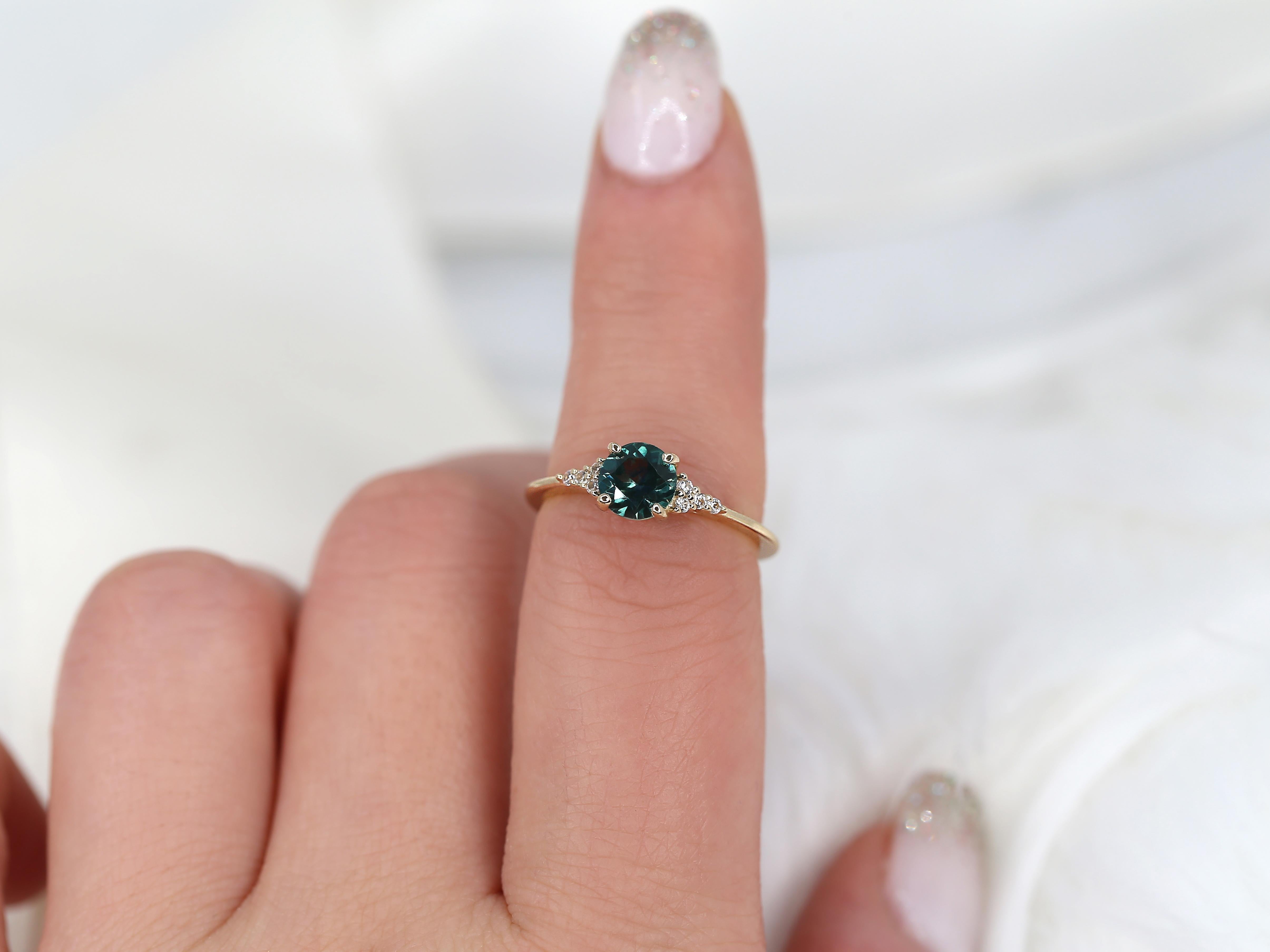 Our American made Malia is mounted with a stunning Montana teal sapphire that is radiant and dazzling in daylight. This cluster ring can easily be worn as a stand alone piece or layered with stacking ring for a dressier look!

Details of