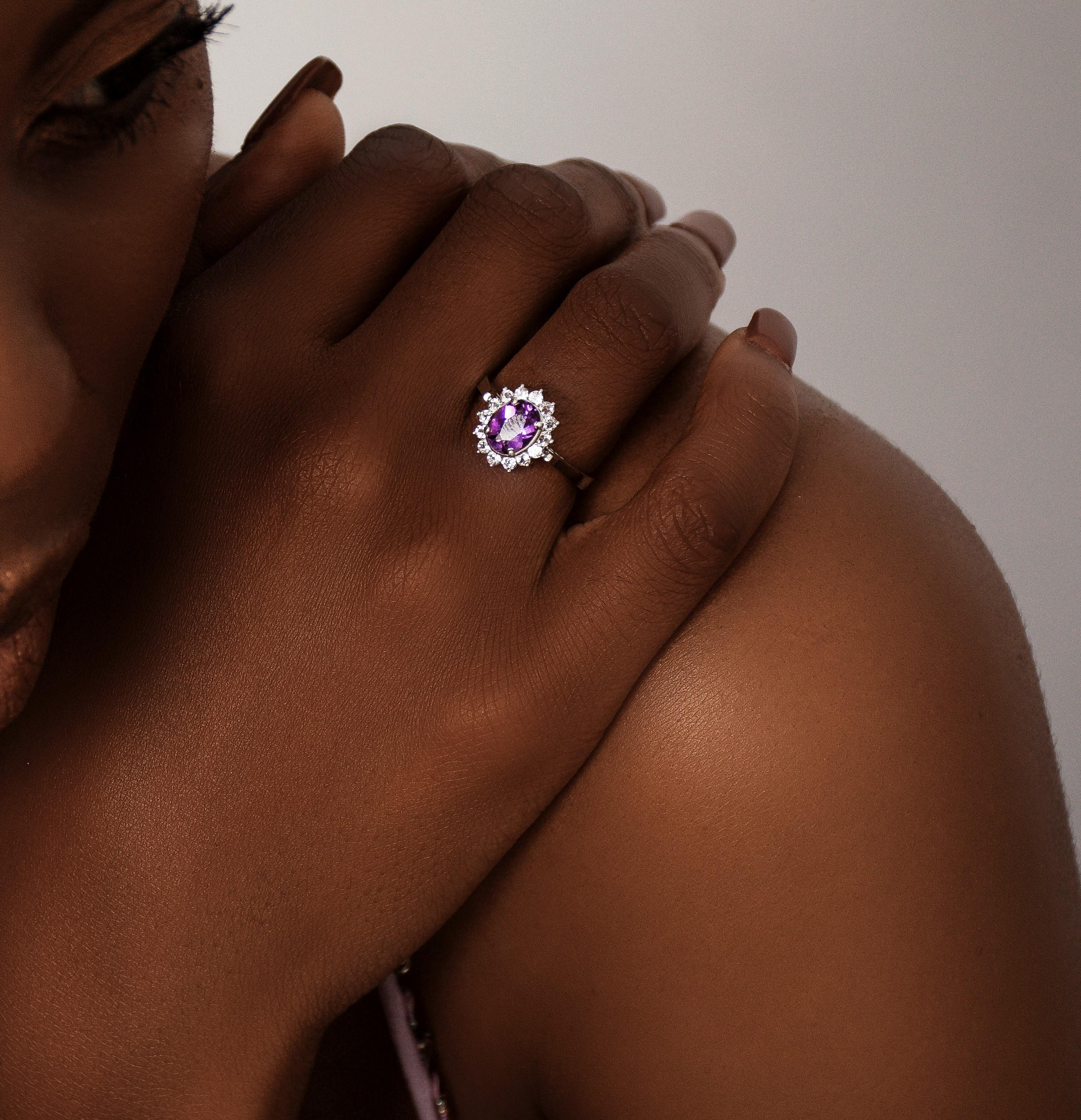 Make a statement with these Elegant 2ct Oval Natural Purple Amethyst and White Zircon Oval ring. It showcases a stunning 7.2x6.8mm oval-shaped natural amethyst, weighing a total of 2 carat. Surrounding the amethyst are 15 dazzling rare natural white