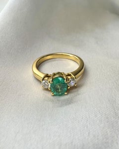 1ct Oval Emerald and .06ct Round Diamonds 3-Stone Ring