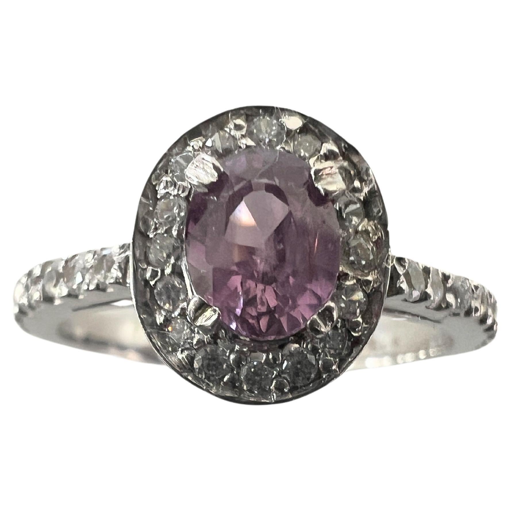 Step into a world of sophistication with our Elegant 1ct Oval Pink Sapphire Ring, a true masterpiece of luxury and design. At its center, a 6.5x5.1mm oval natural origin pink sapphire glows with a captivating hue, symbolizing love and passion on a