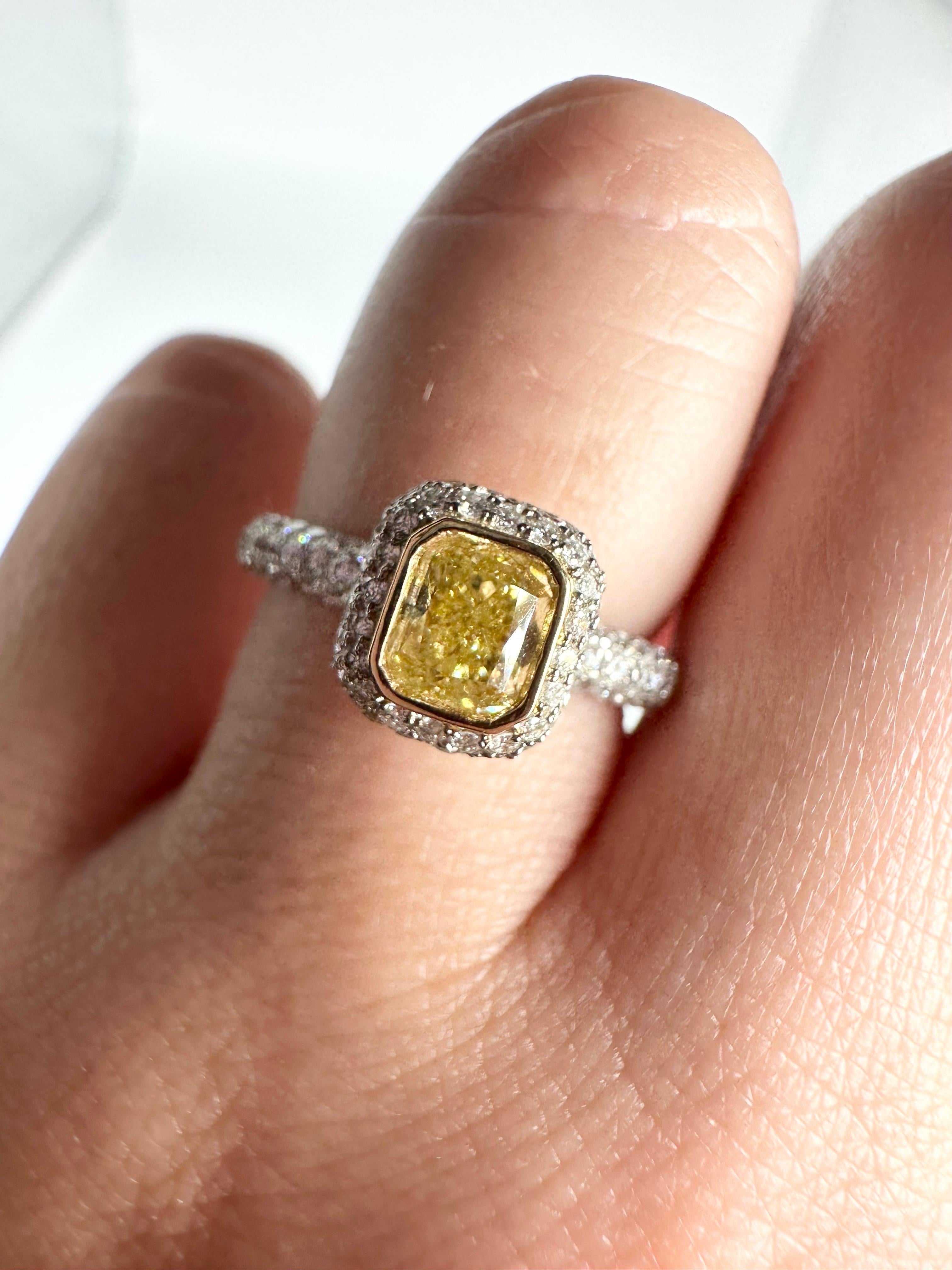 Remarkable 1ct center diamond ring with a stunning fancy yellow diamond and pave diamonds throughout in 18kt white gold, this is a custom made ring with stunning personality and luxurious design!

GOLD: 18KT gold
NATURAL DIAMOND(S)
Clarity/Color: