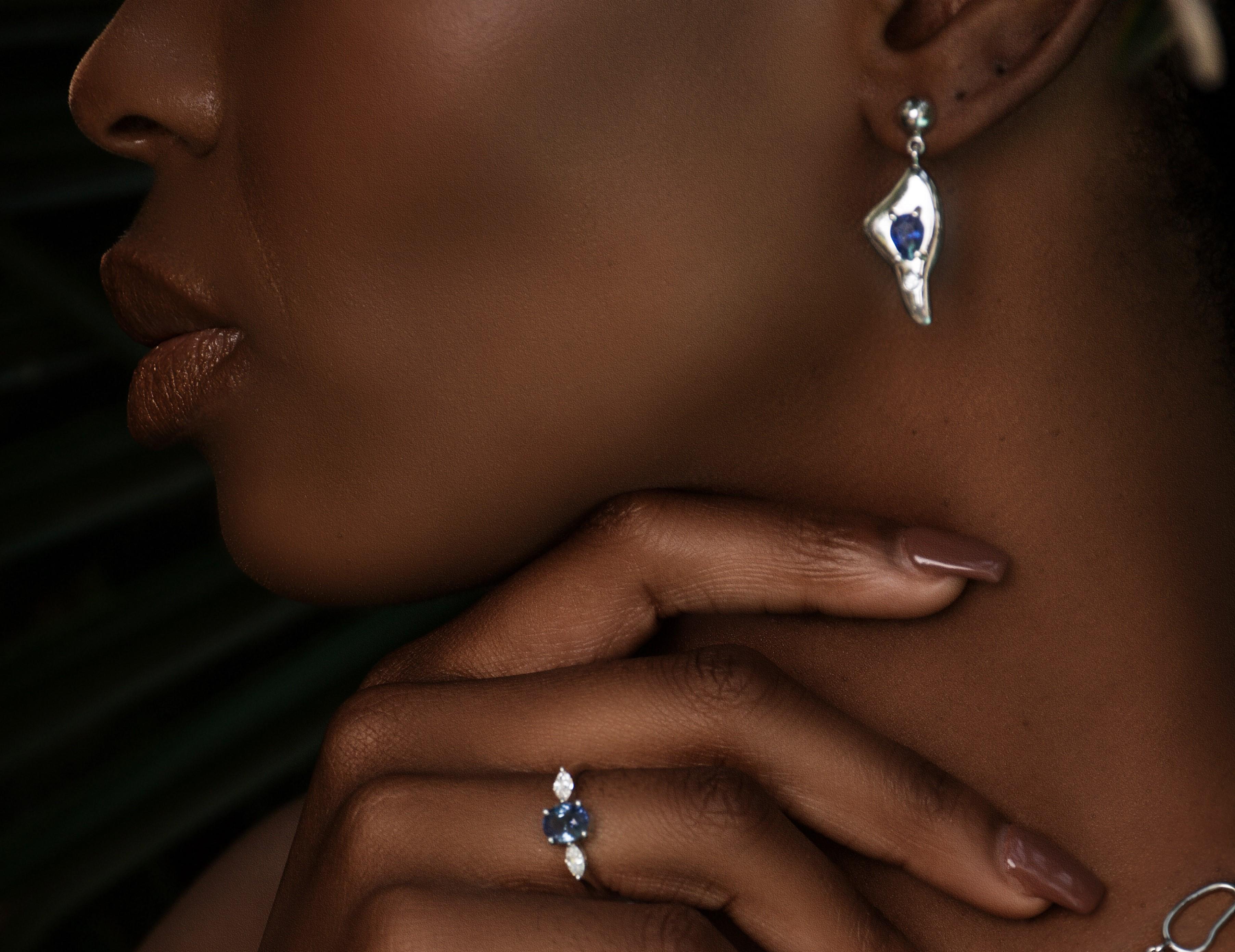 Our Pear Cut Sapphire Leaf Drop Earrings—a delicate symphony of nature's beauty captured in every facet.
Adorning each earring is a 1ct pear-cut sapphire, expertly faceted to enhance its brilliance and depth of color. The pear cut, with its teardrop