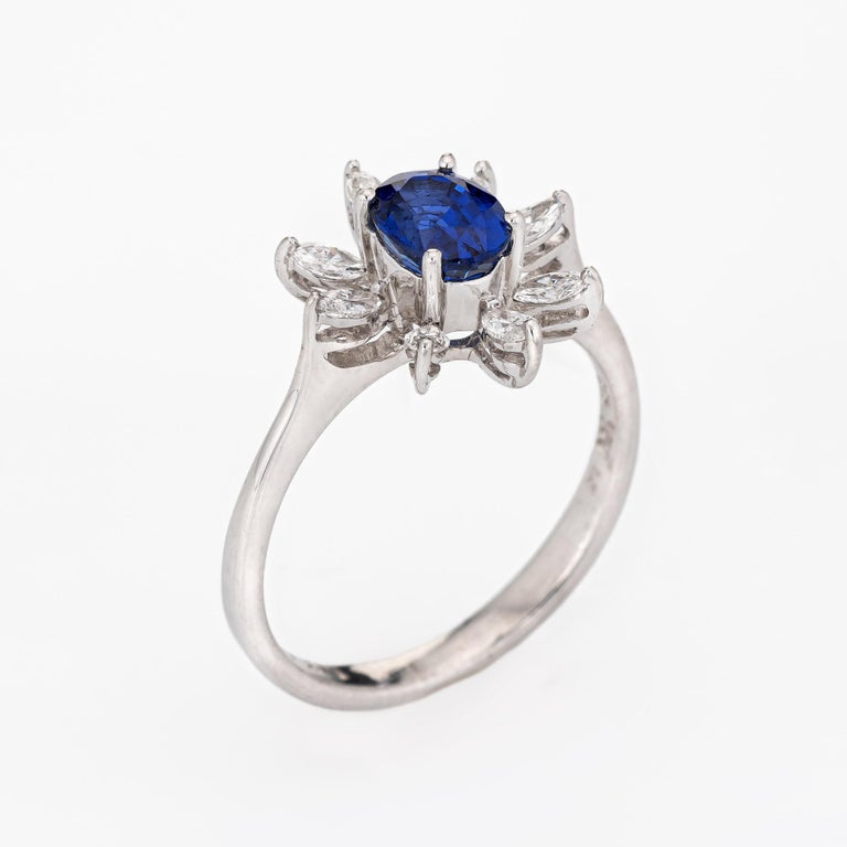 Stylish estate 1ct royal blue sapphire & diamond ring (circa 2000s) crafted in 18 karat white gold. 

Oval faceted royal blue sapphire is estimated at 1 carat, accented with 8 marquise cut diamonds that total an estimated 0.36 carats (estimated at