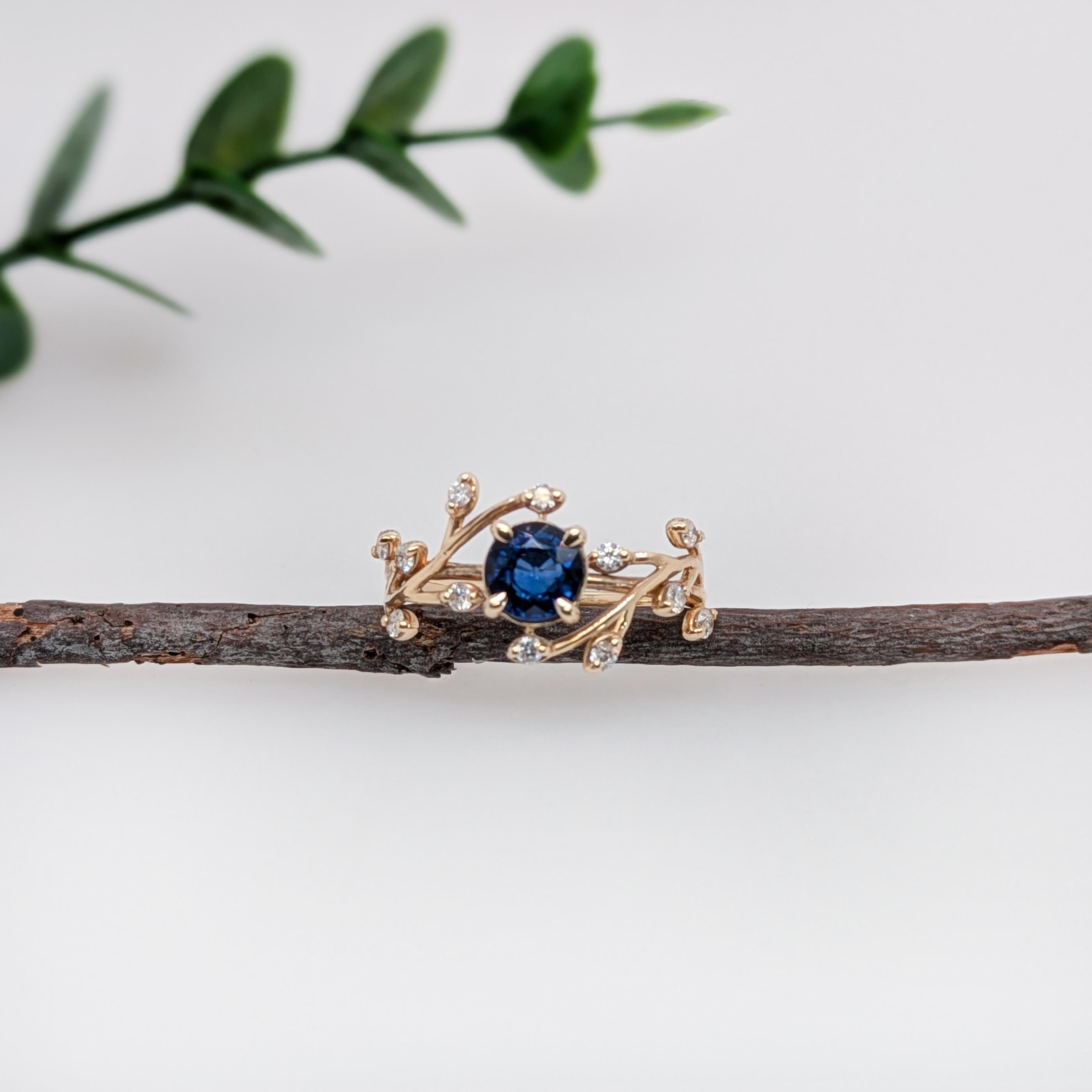 This beautiful dainty ring features a velvet blue sapphire in 14k yellow gold with a vine design with earth mined diamond accents. A nature inspired ring design perfect for an eye catching engagement or anniversary. This ring also makes a beautiful