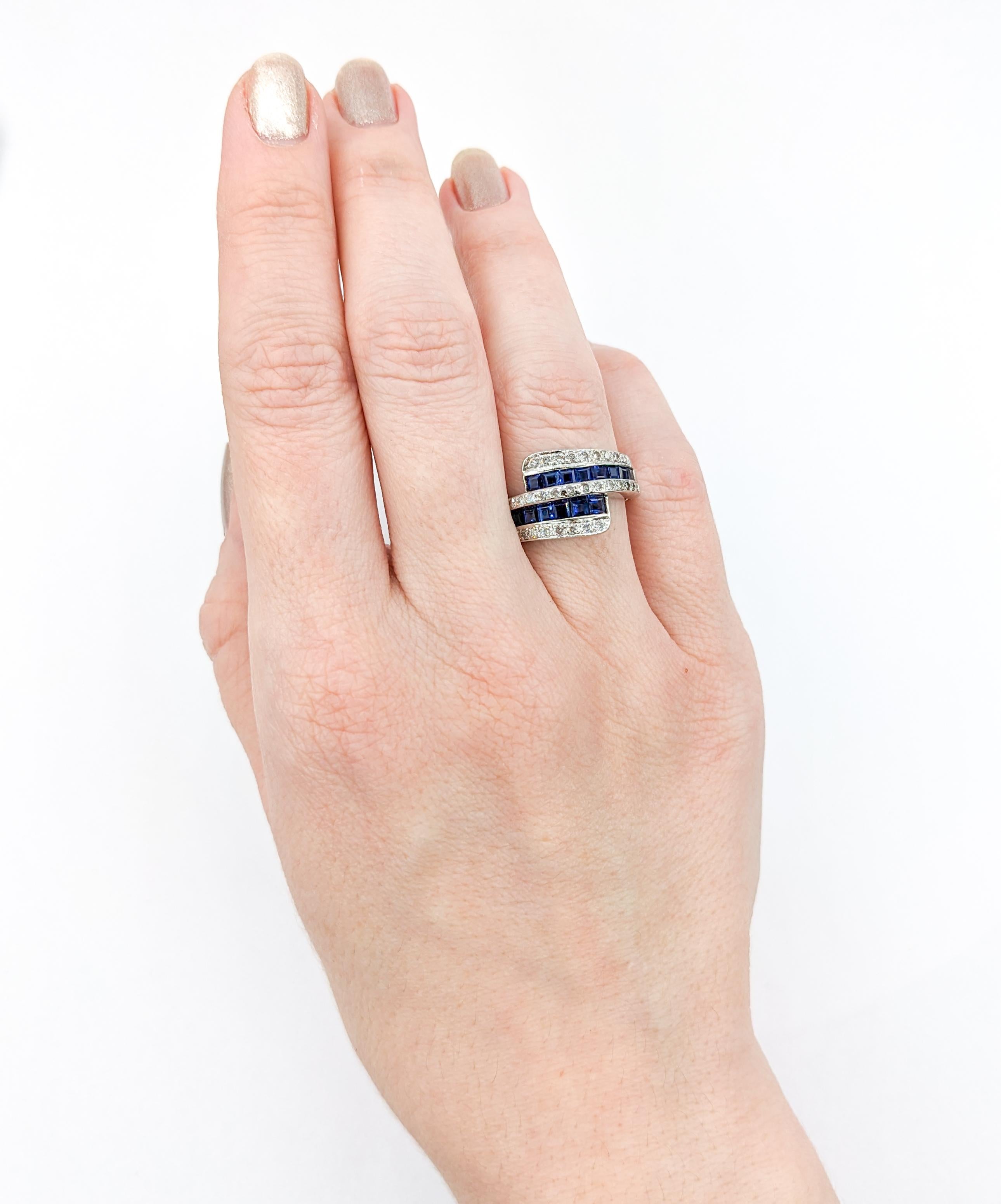 1ctw Blue Sapphire & Diamond Ring In White Gold

Discover the radiance of this exquisite bypass ring, masterfully crafted from 14kt white gold, featuring .25 carats of round diamonds. These diamonds glimmer with an 'I' clarity and a near colorless
