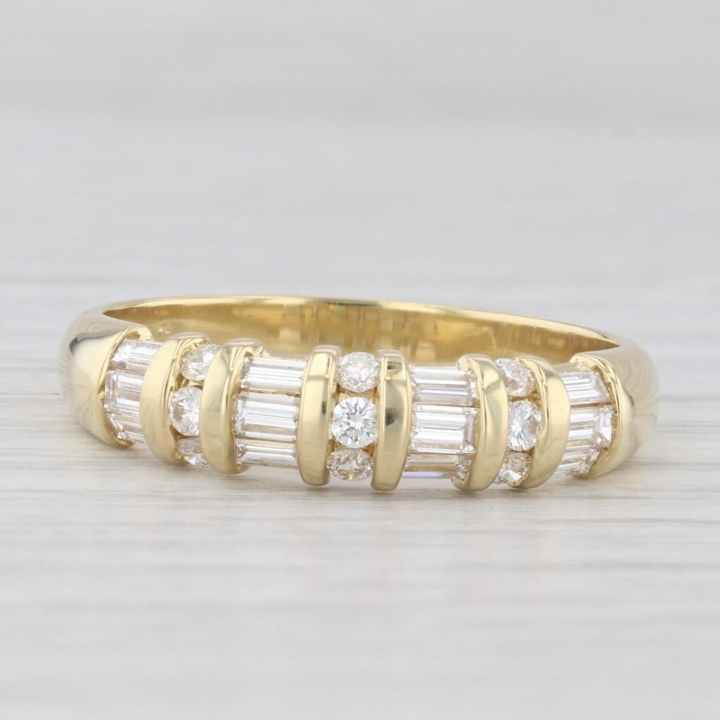 Gemstone Information:
- Natural Diamonds -
Total Carats - 1ctw
Cut - Round Brilliant 0.27ctw, Baguette 0.73ctw
Color - F - G
Clarity - VS1 - VS2

Metal: 18k Yellow Gold
Weight: 6.5 Grams 
Stamps: 18k
Face Height: 5.7 mm 
Rise Above Finger: 3.4