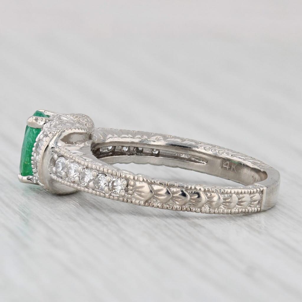 Gemstone Information:
- Natural Emerald -
Carats - 0.75ct 
Cut - Oval
Color - Green
Treatment - Oiling

- Natural Diamonds -
Total Carats - 0.25ctw
Cut - Round Brilliant
Color - G - H
Clarity - SI1 - SI2

Metal: 14k White Gold
Weight: 5.6 Grams