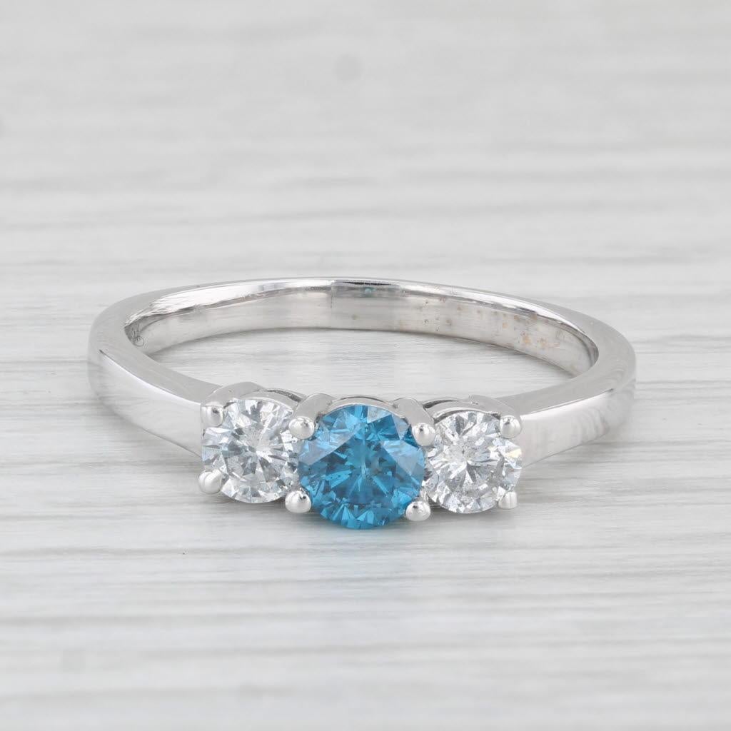 Gemstone Information:
- Natural Diamond -
Carats - 0.50ct 
Cut - Round Brilliant
Color - Blue
Clarity - I1
Treatment - Iradiated 

- Natural Diamonds -
Total Carats - 0.50ctw
Cut - Round Brilliant
Color - G - H
Clarity - I1 - I2

Metal: 14k White