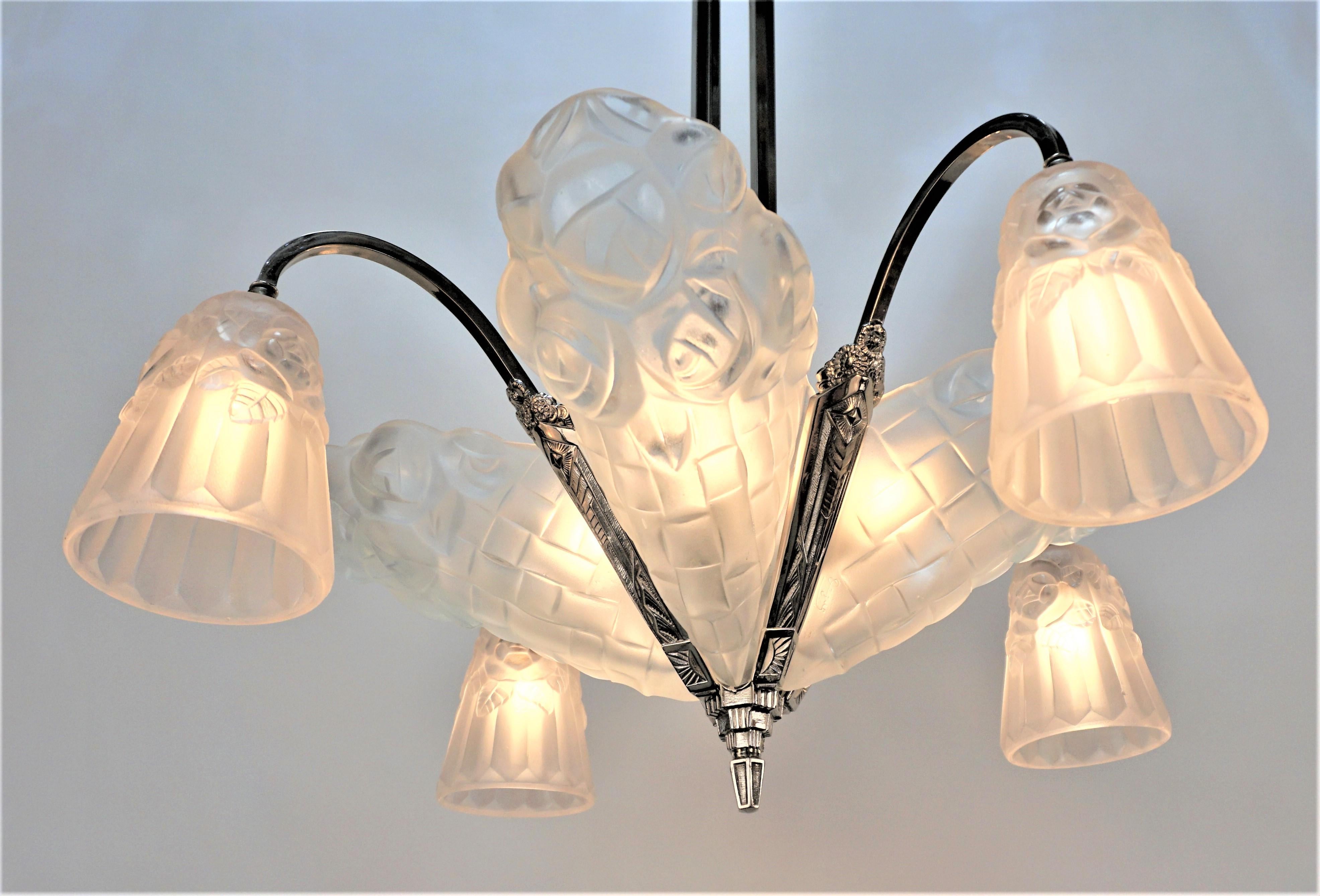 French 1930's clear frost glass art deco chandelier with four slip shades and four down lights. Frame is nickel on bronze with total of eight lights.
60watts max each light.