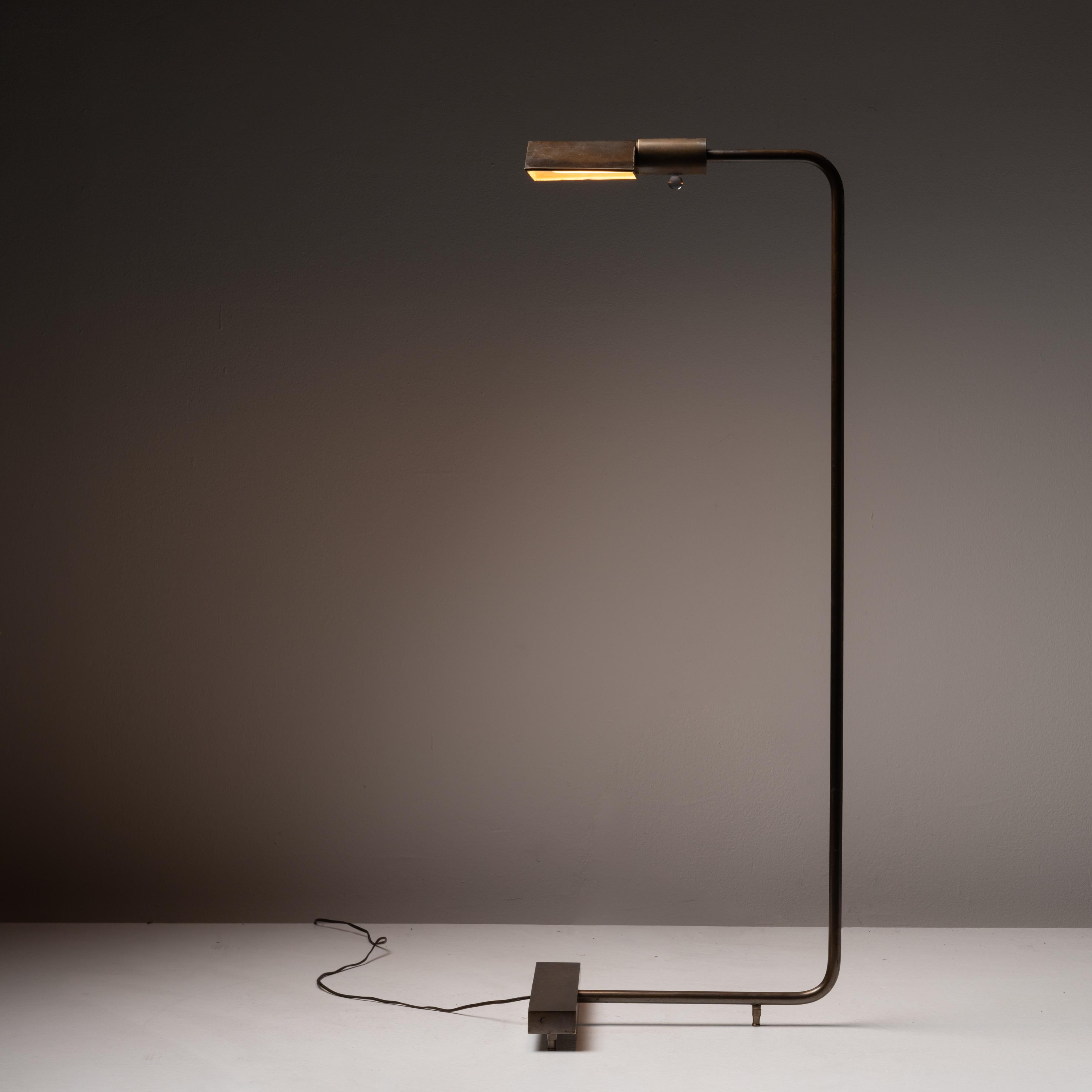 1MUWV Floor Lamp by Cedric Hartman. Designed and manufactured in the United States, in 1969. Early edition brass floor lamp, with triangular shade and rectangular weighted beam on the base. Holds one E26 socket. We recommend using a 40w maximum