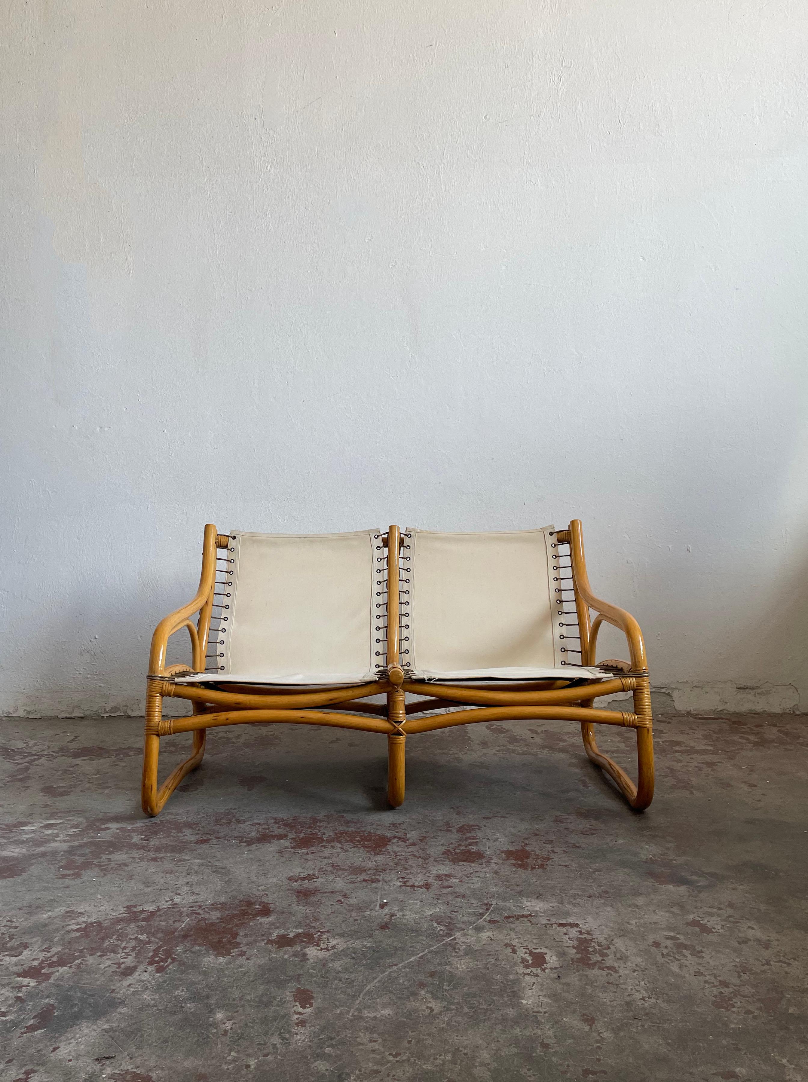 Vintage bamboo 2-seater sofa from the 1970s.

Produced in Scandinavia by an unknown manufacturer. The quality of the production is very high.

The sofa features a bamboo frame with durable fabric strapping and a high-quality light blue (turquoise)