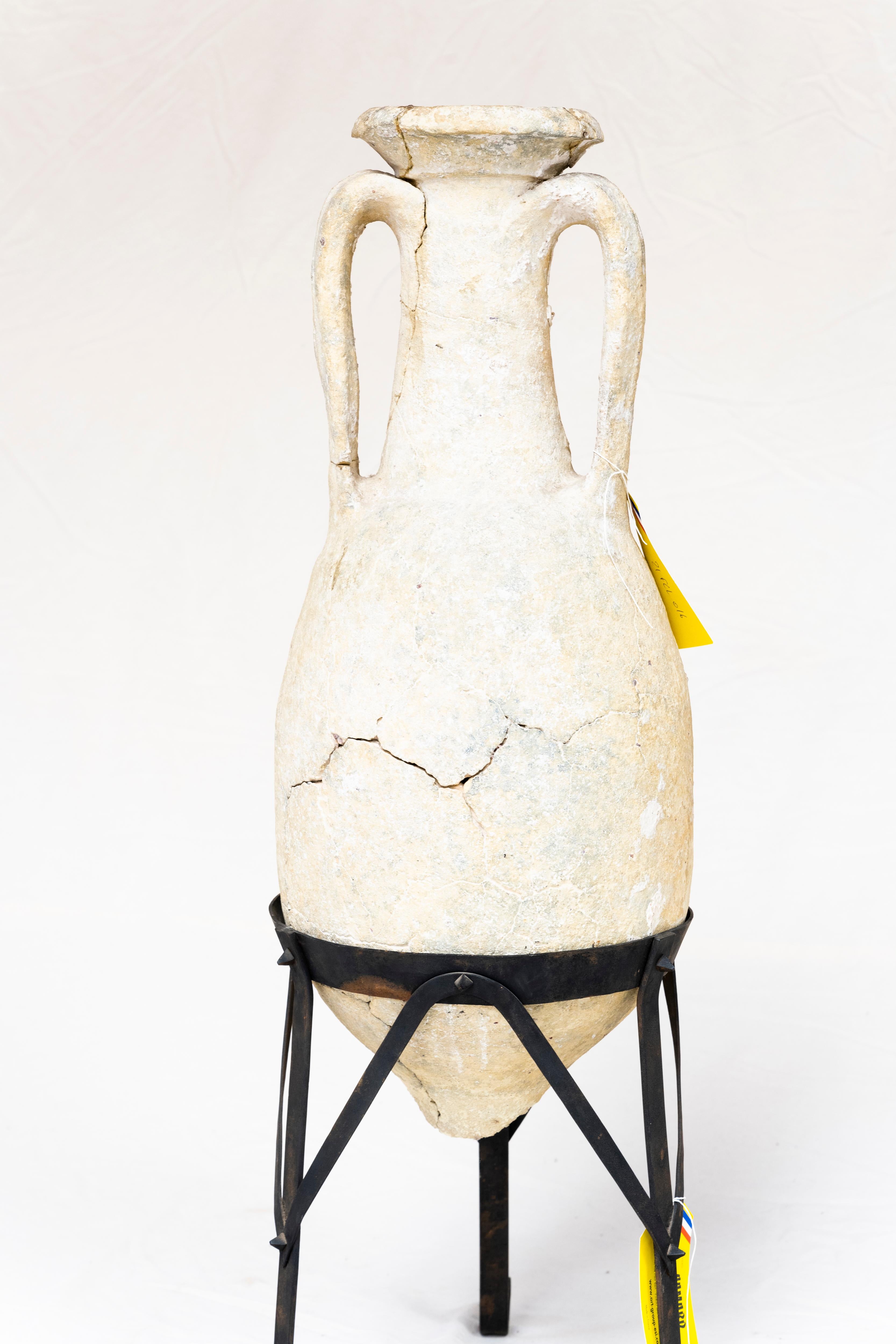 This 1st century Roman amphora was discovered in the 1970s by a well-respected French female archeologist at the bottom of the Adriatic Sea, and reconstituted. It remained in her personal collection until her death, and sits in a custom iron stand.