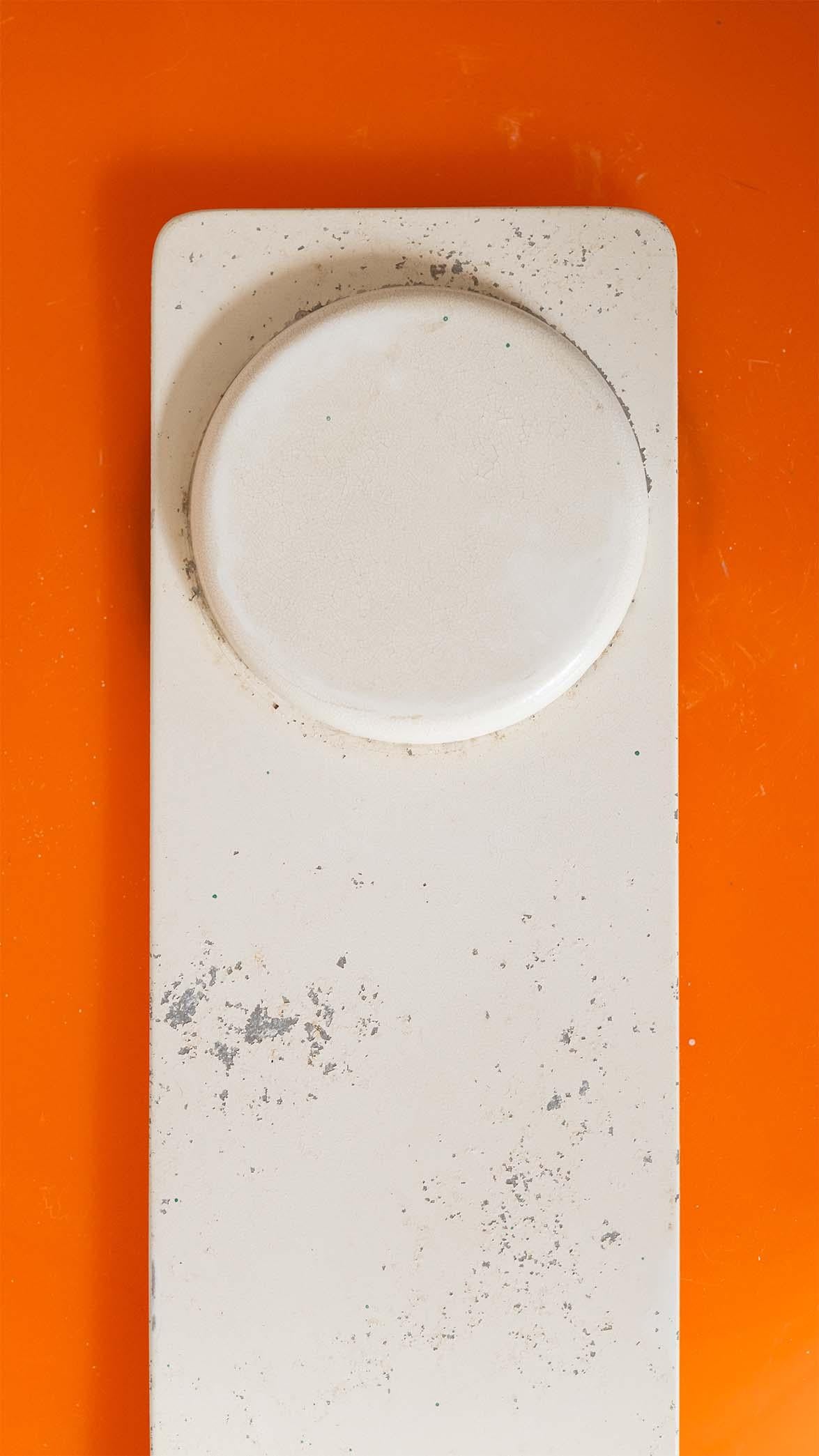 A rare 1st edition of the 'Alvise' lamp designed by Luigi Massoni for Harvey Guzzini - 

This edition features an earlier design that differs slightly from later versions, with a white frame and arch that suspends an orange dome shade. The scale of
