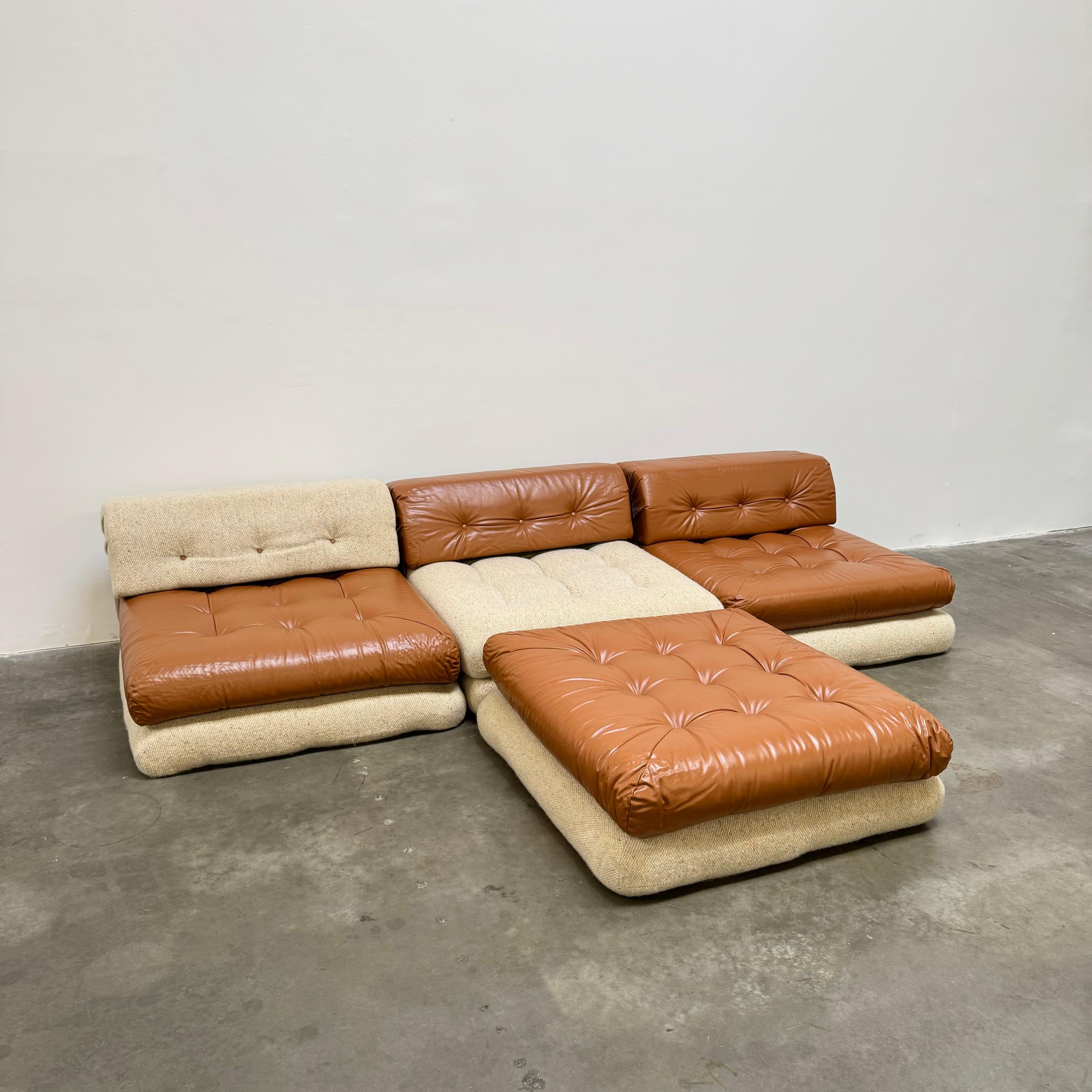 Discover the elegance of an extremely rare 1st edition Roche Bobois Mah Jong sofa, designed by Hans Hopfer circa 1971.

This exquisite piece is beautifully upholstered in sumptuous cognac leather and plush wool, combining rich textures that enhance
