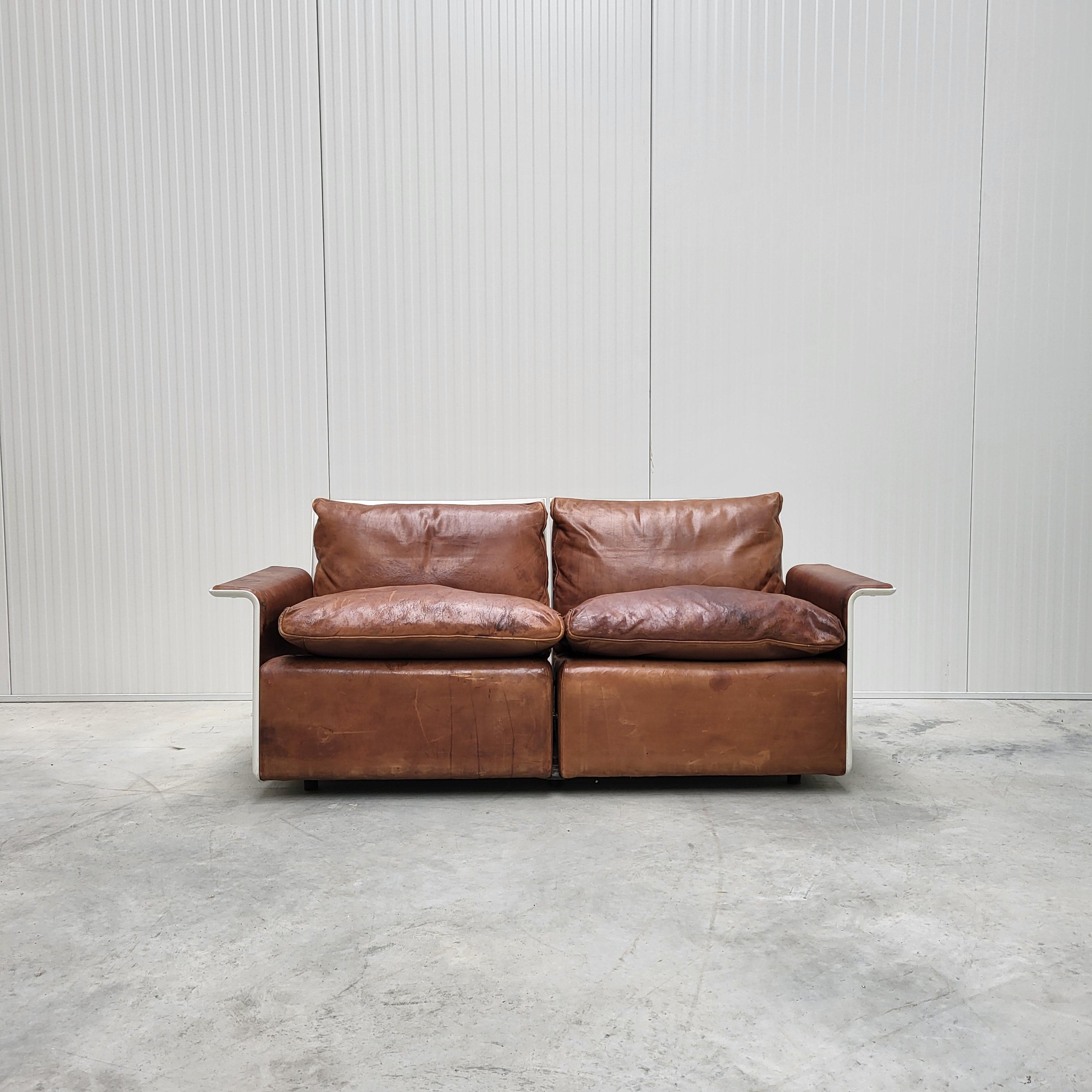 This timeless iconic sofa was made in the early 60s by Vitsoe and designed by Dieter Rams.
The sofa comes from the iconic RZ620 series and is a first generation example. 

The sofa is upholstered in an amazing super smooth Mid Brown leather and