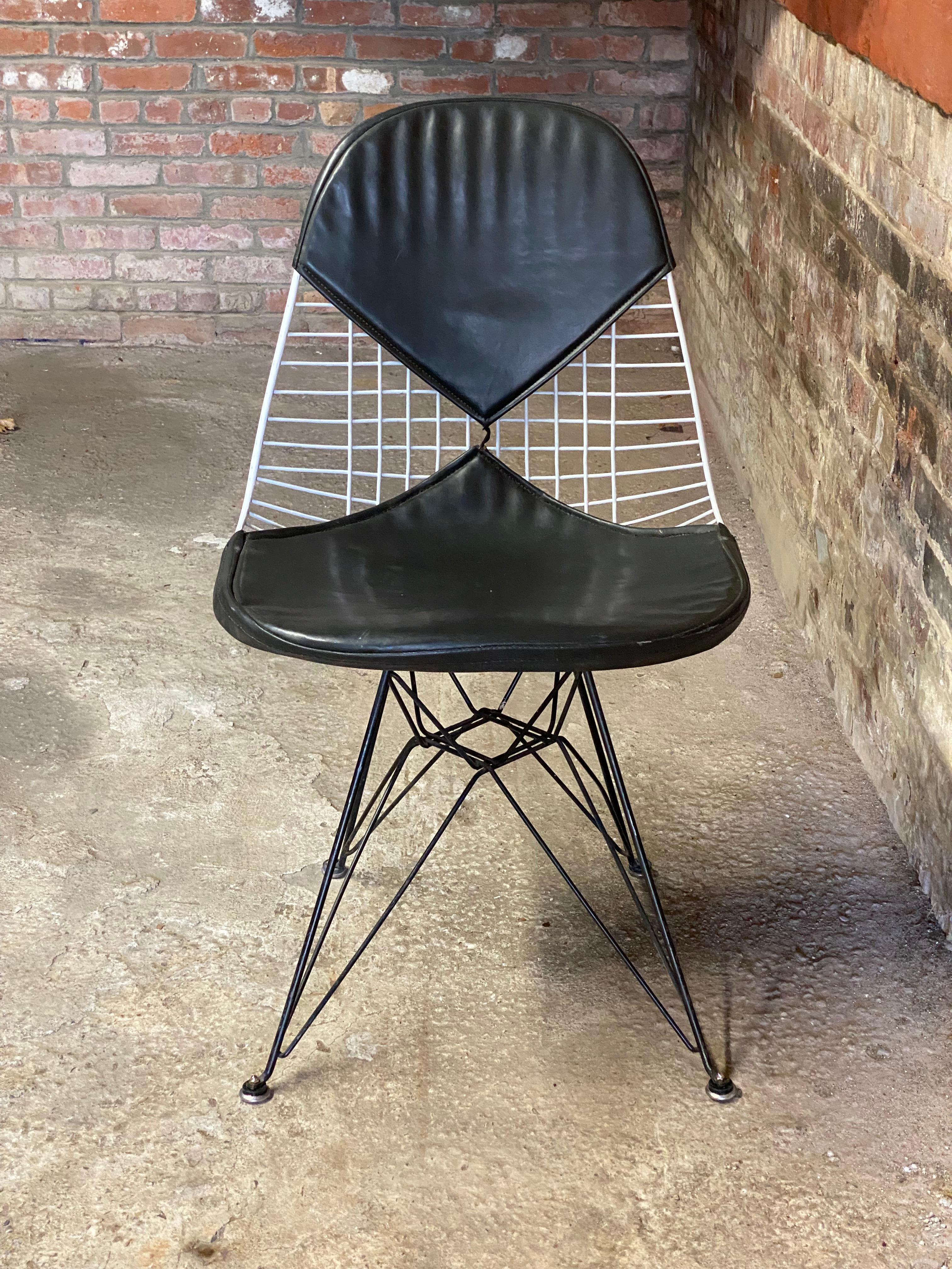 First generation Eames DKR-2 Eiffel Tower base side chair with the distinct splayed feet and the black base (which was only released in the early version). The Bikini chair's cover is all original. The bikini cover still retains the original Herman