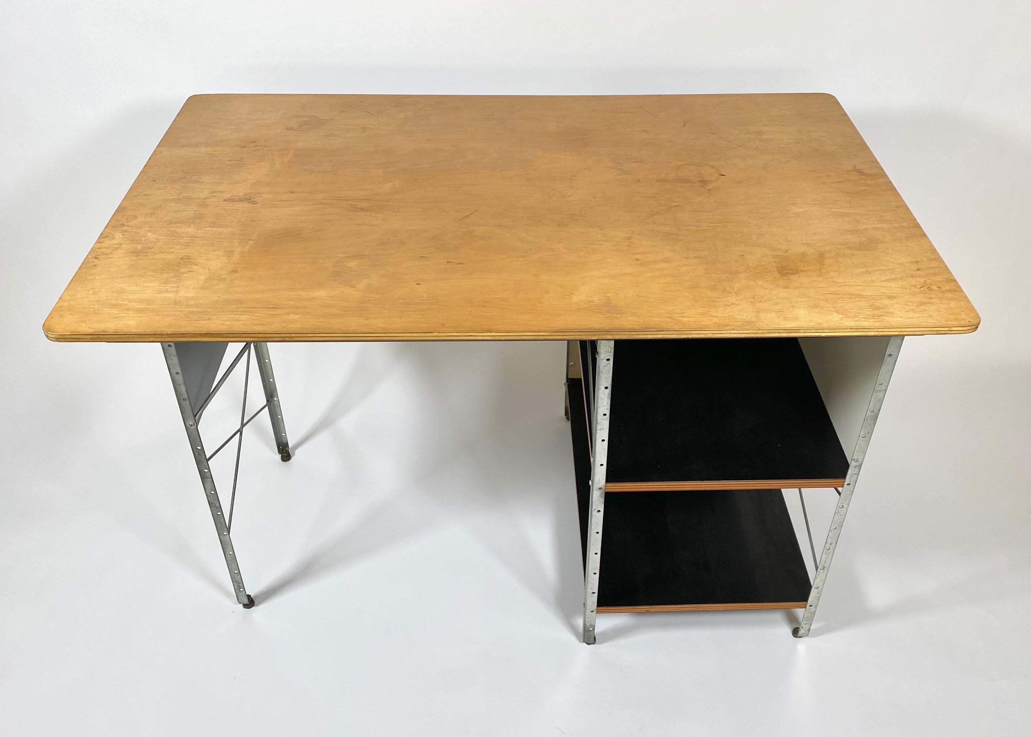 First production Eames ESU D-10-N desk 1950/ 1951 with a birch plywood top, zinc plated steel and lacquered gray and white masonite panels. These were only produced for two years after which they were modified and reintroduced in 1952. The desk was