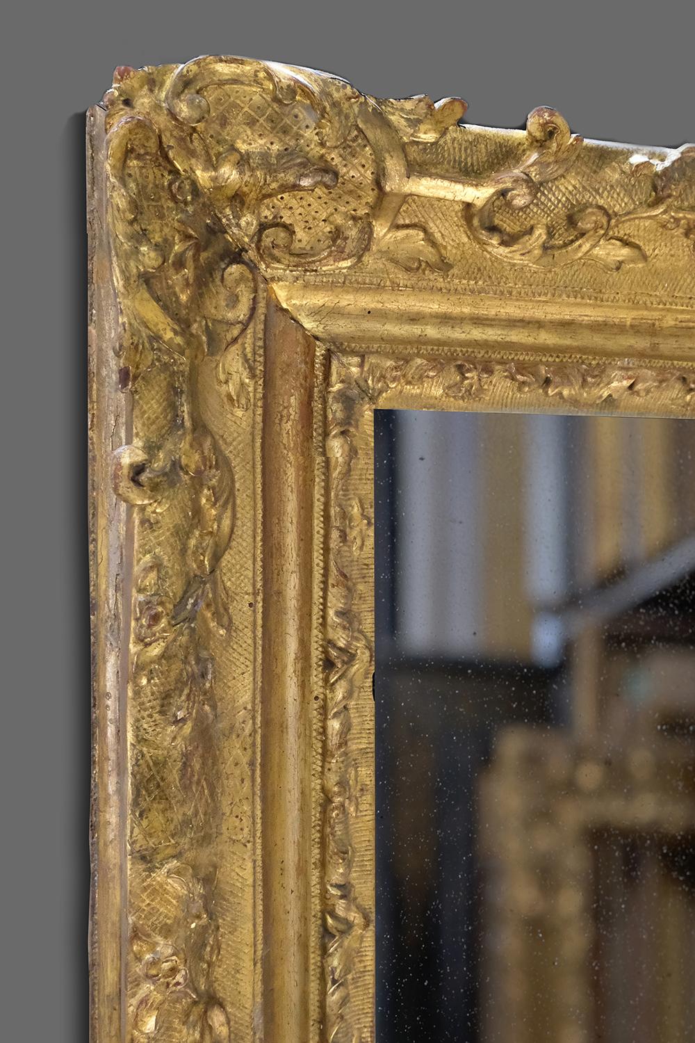 This is a stunning and rare 1st half 18th century hand carved French, Provincial late Baroque frame, with ogee and cavetto profile. It is carved with foliate scroll-&-flower corners and centers on a cross-hatched ground, with quadrillage panels;