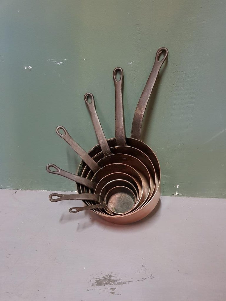 Old French 7-piece copper pan set with metal handles and without it's tinned inside and it got a beautiful patina by age, from the first half of the 20th century. 

The measurements are,
Diameter 6.5, 8.5, 10, 12, 14.5, 16.5 and 18.5 cm/ 2.5,