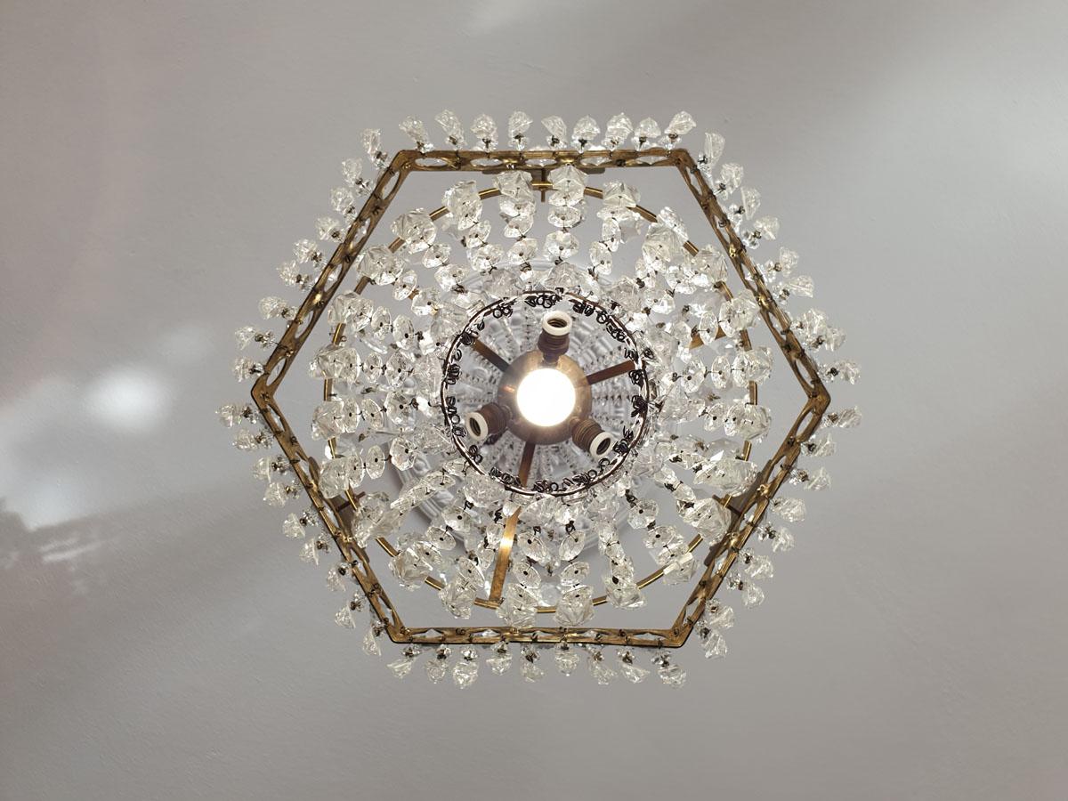 Unusual shape, interesting, original crystal chandelier with a very decorative pattern.

Slim proportions make it ideal for tall and narrow rooms.
Some crystals in the form of arrowheads and porcelain frames which is quite rare.
1 tier, 4