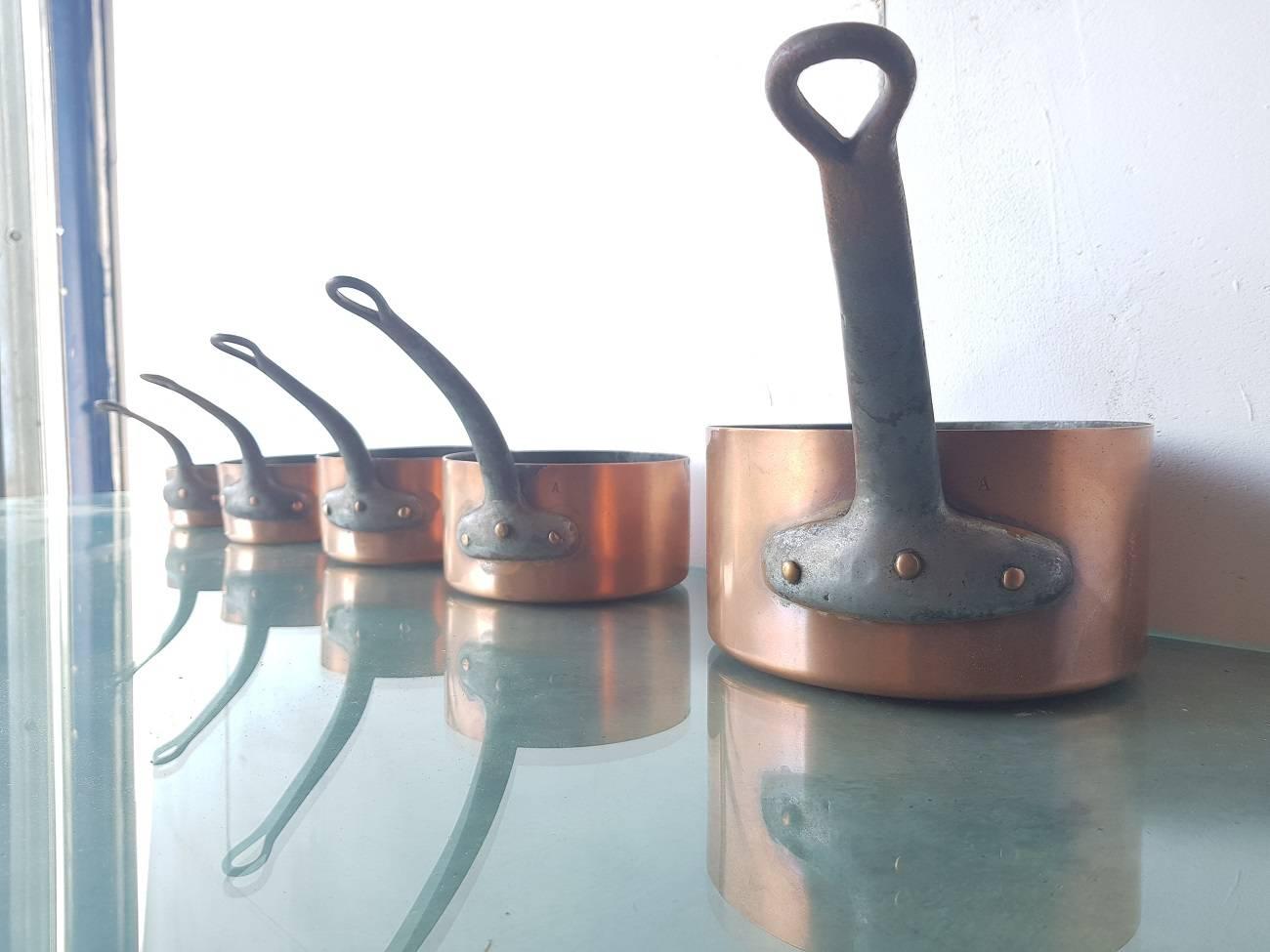 Old French copper cookware consisting of five parts all with tinned inside and metallic handles. These were made in the first half of the 20th century and in a used condition.

The measurements are 11 cm/ 4.3 inch, 13.5 cm/ 5.3 inch, 14.5 cm/ 5.7