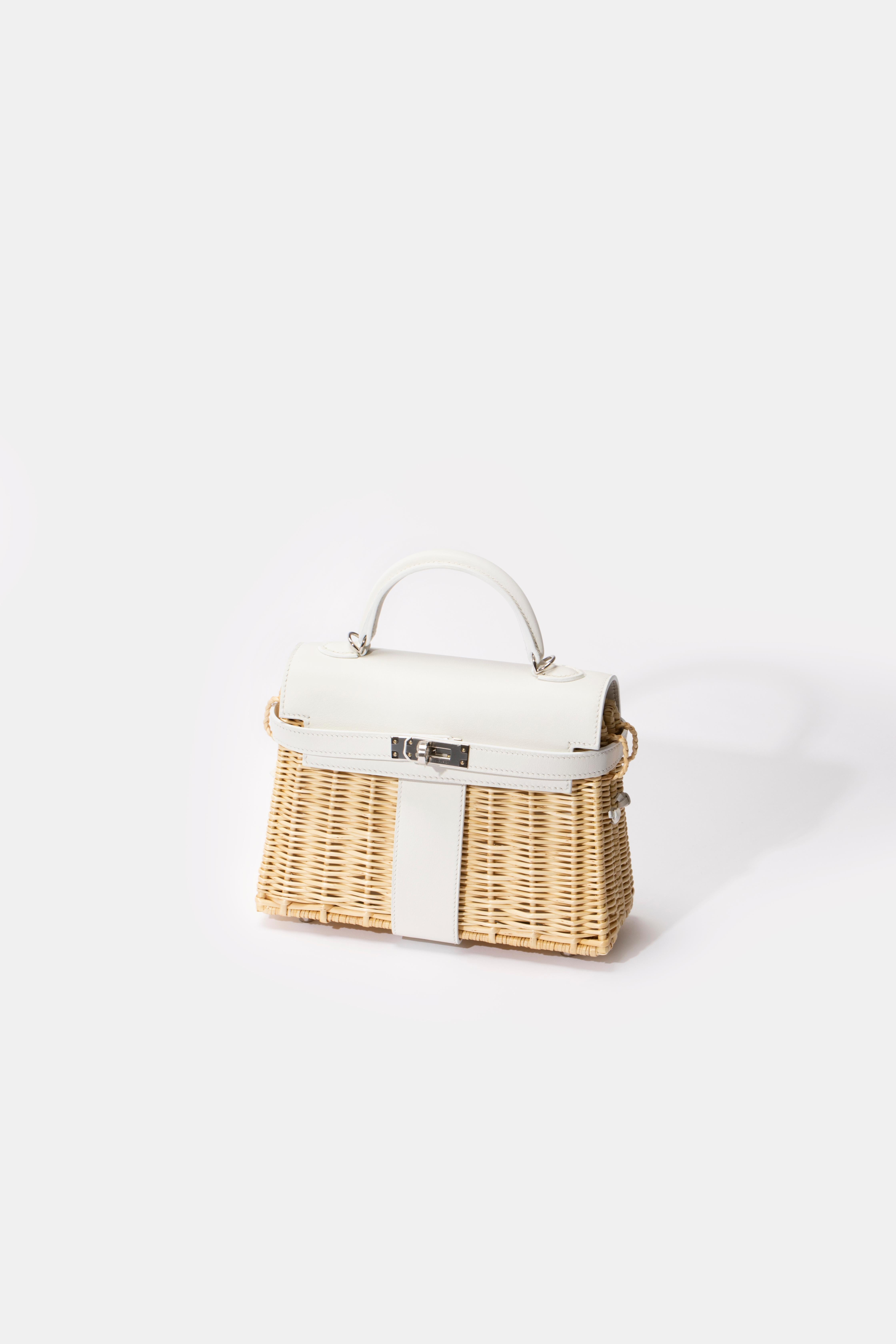 1stdibs Exclusives From Three Over Six

Brand: Hermès 
Style: Kelly
Size: Mini Picnic 
Color: White
Leather: Swift and Wicker 
Hardware: Palladium
Stamp: 2020 Y

Condition: Pristine, never carried: The item has never been carried and is in pristine