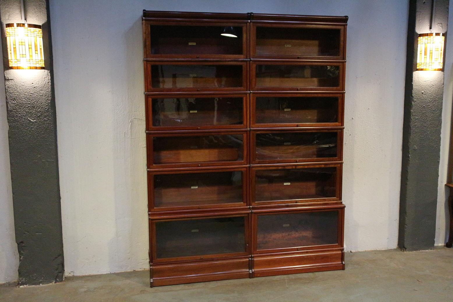 Beautiful antique mahogany Globe Wernicke bookcase. Entirely in perfect condition. The cabinet is made up of 12 stackable elements. Where the lower elements are deeper (file format). Cabinets can be used for multiple purposes. As a bookcase, display